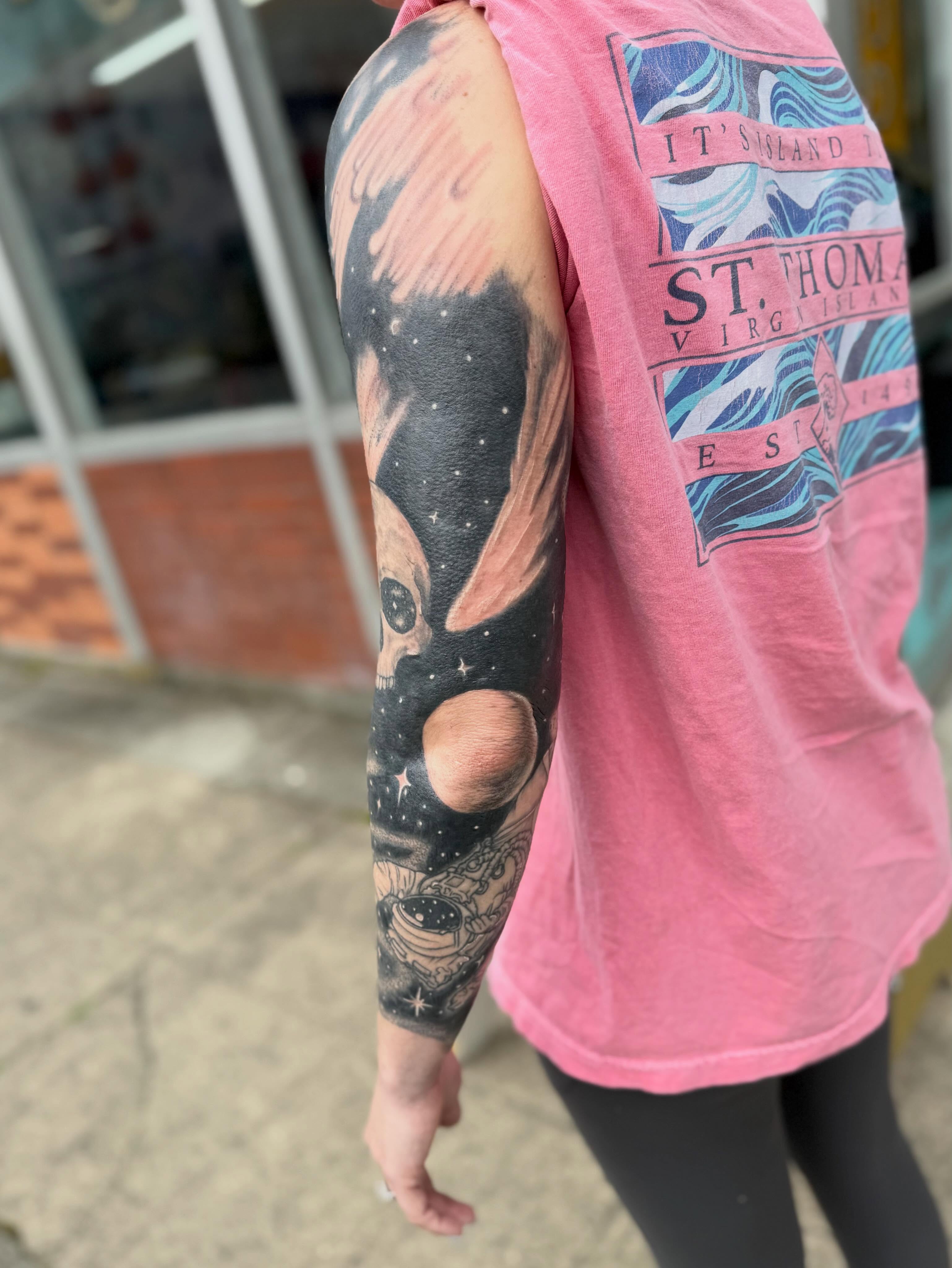 Astronaut in space realism tattoo on the upper arm by Levi Sawdon, Everett, Washington