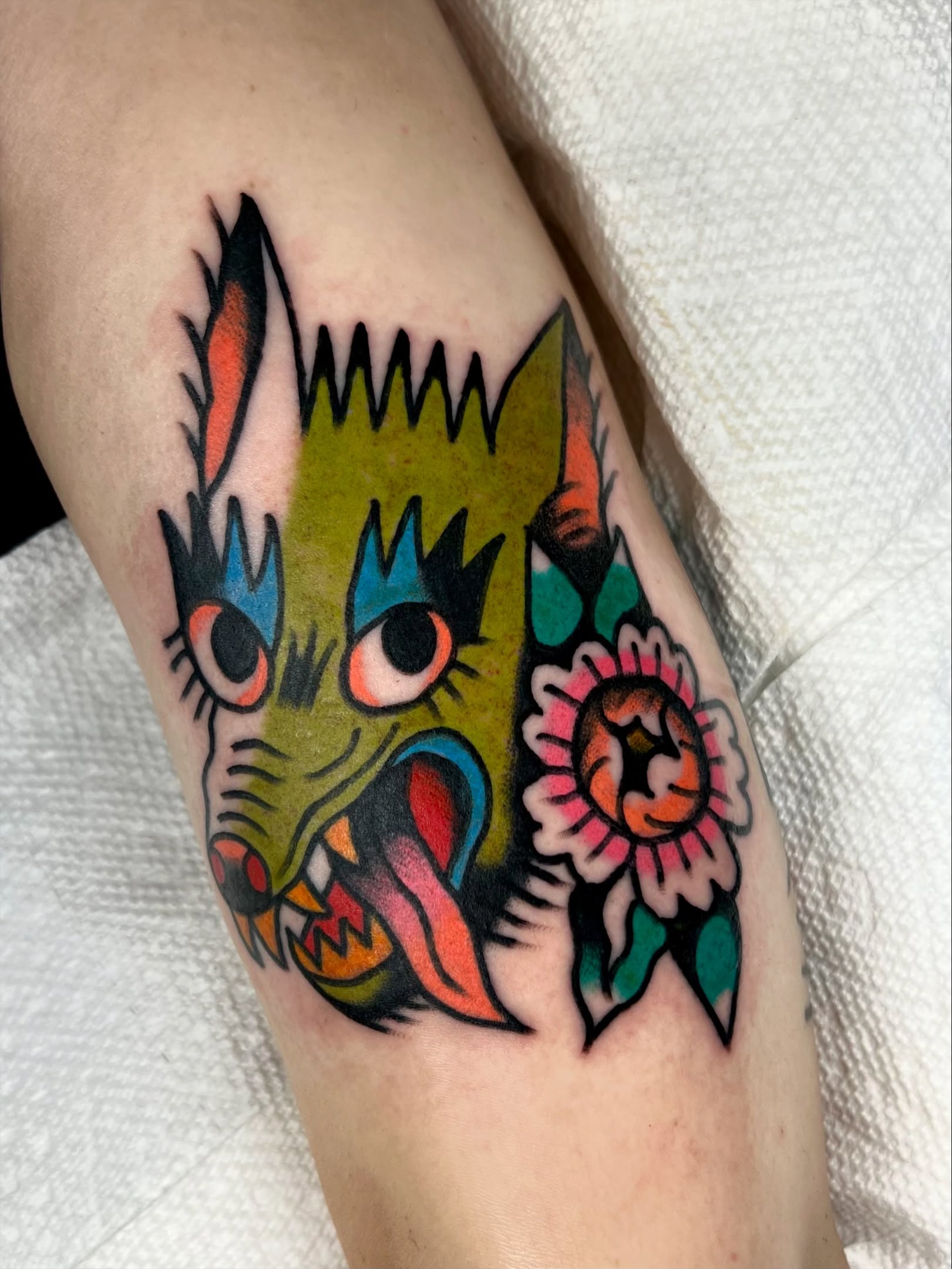 Cat head American traditional tattoo on the forearm by Sierra Mack