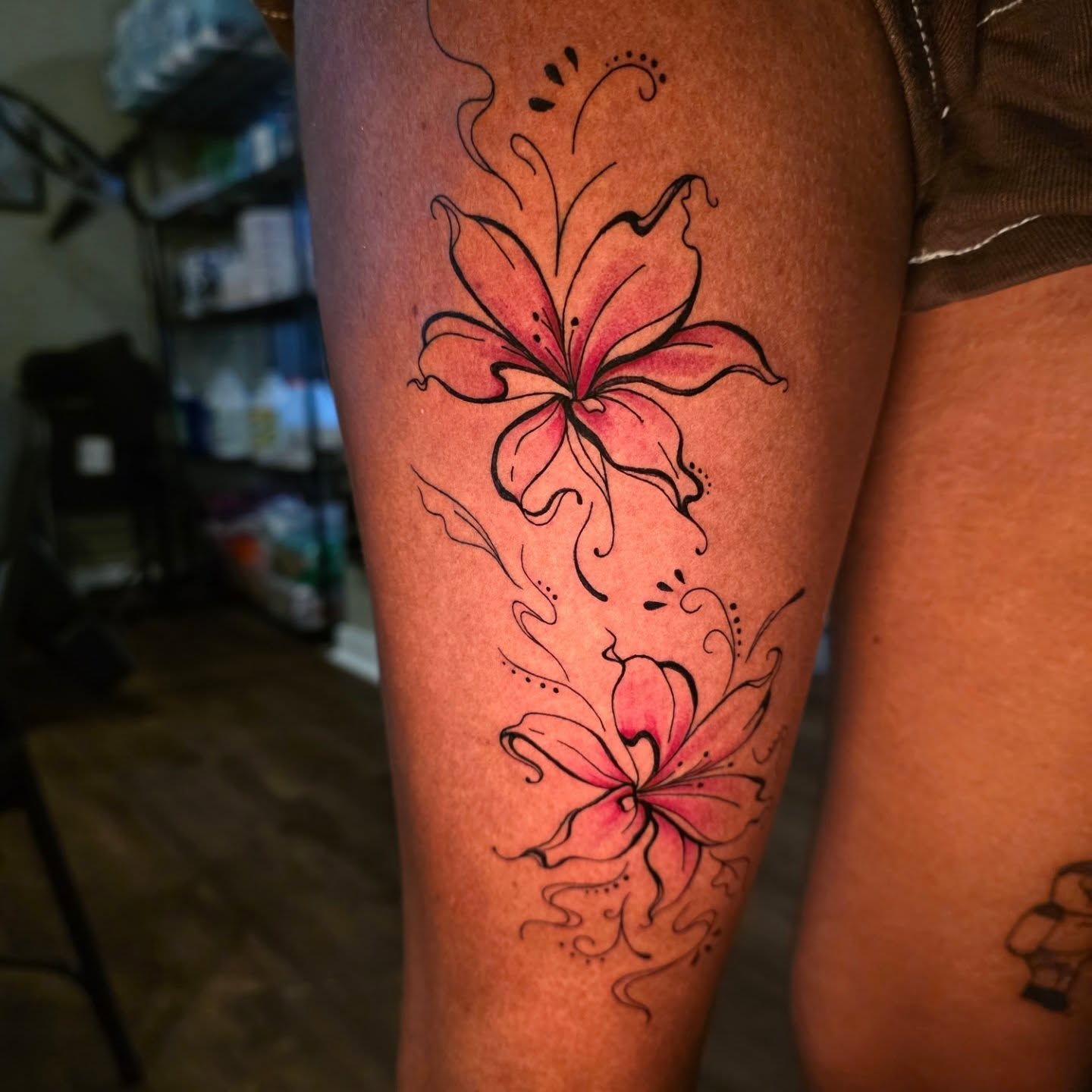 Lily flowers dotwork tattoo on the thigh by Maggie