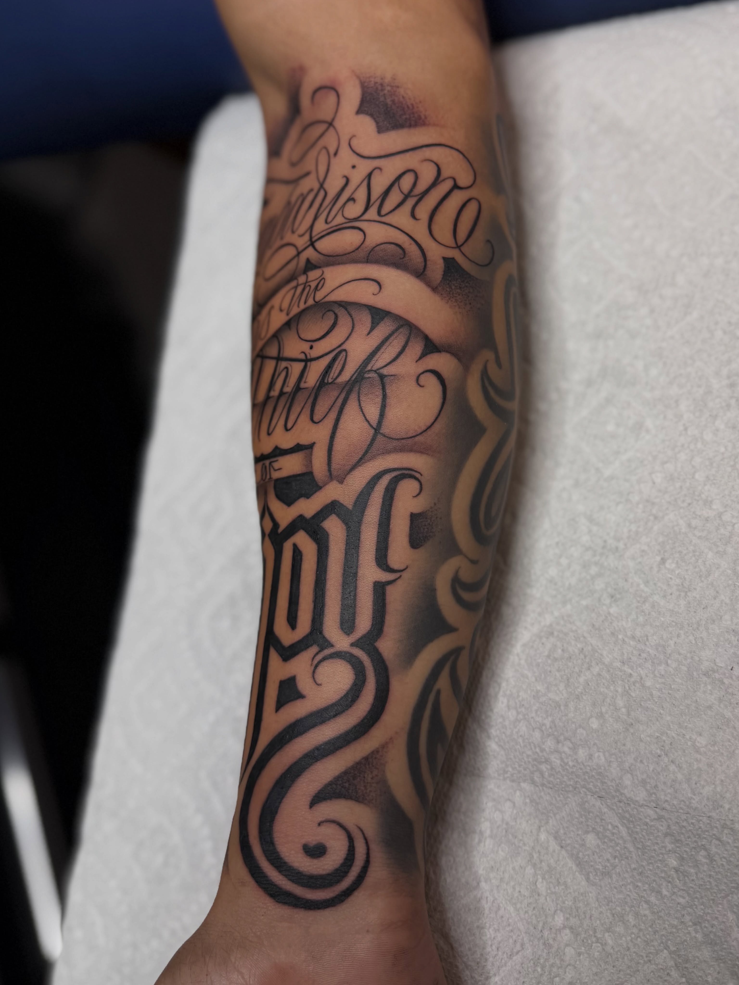 Script lettering lettering script tattoo on the forearm by Rocky G Inkz LLC