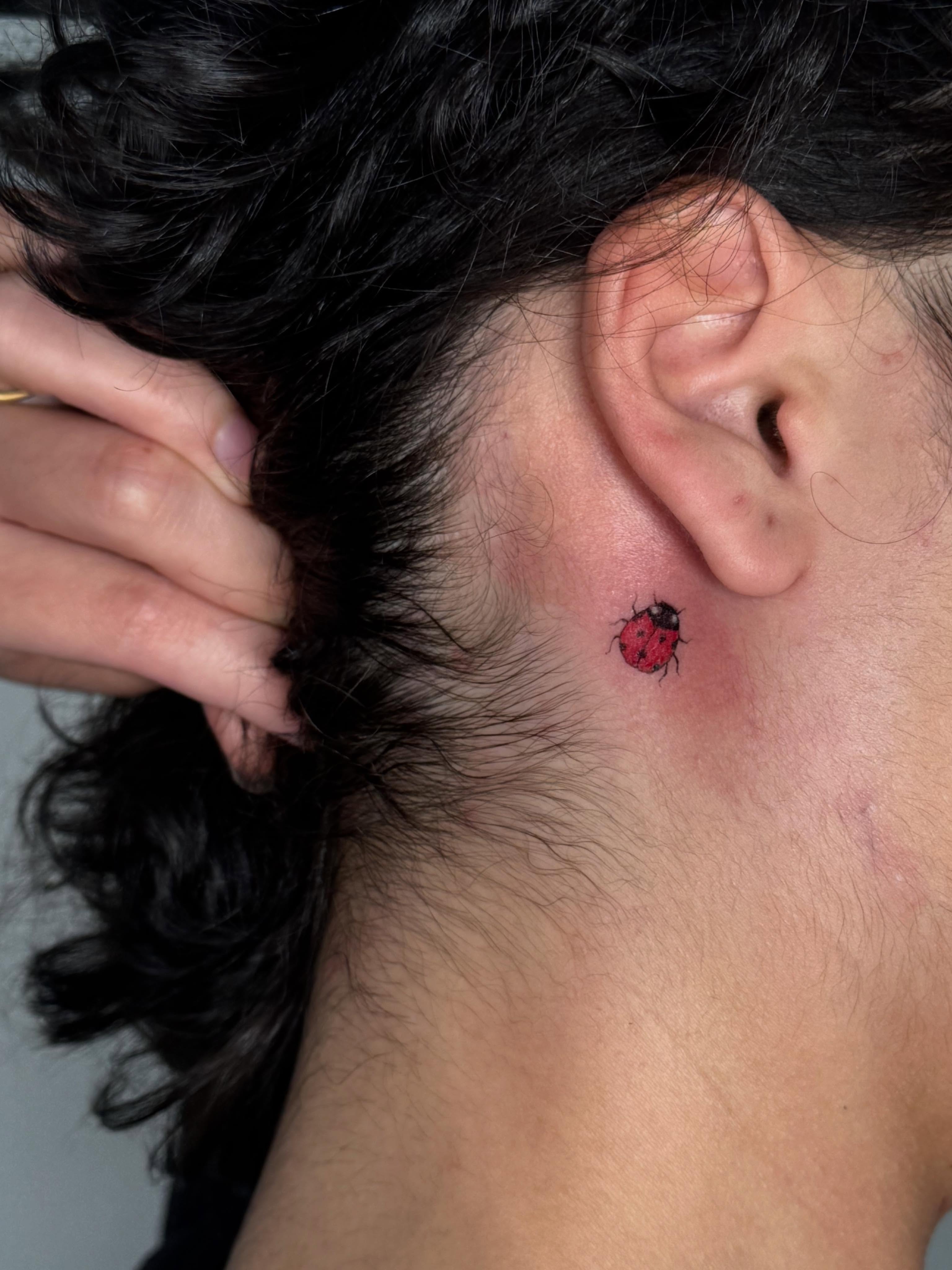 Ladybug realism tattoo on the neck by Danae Andino