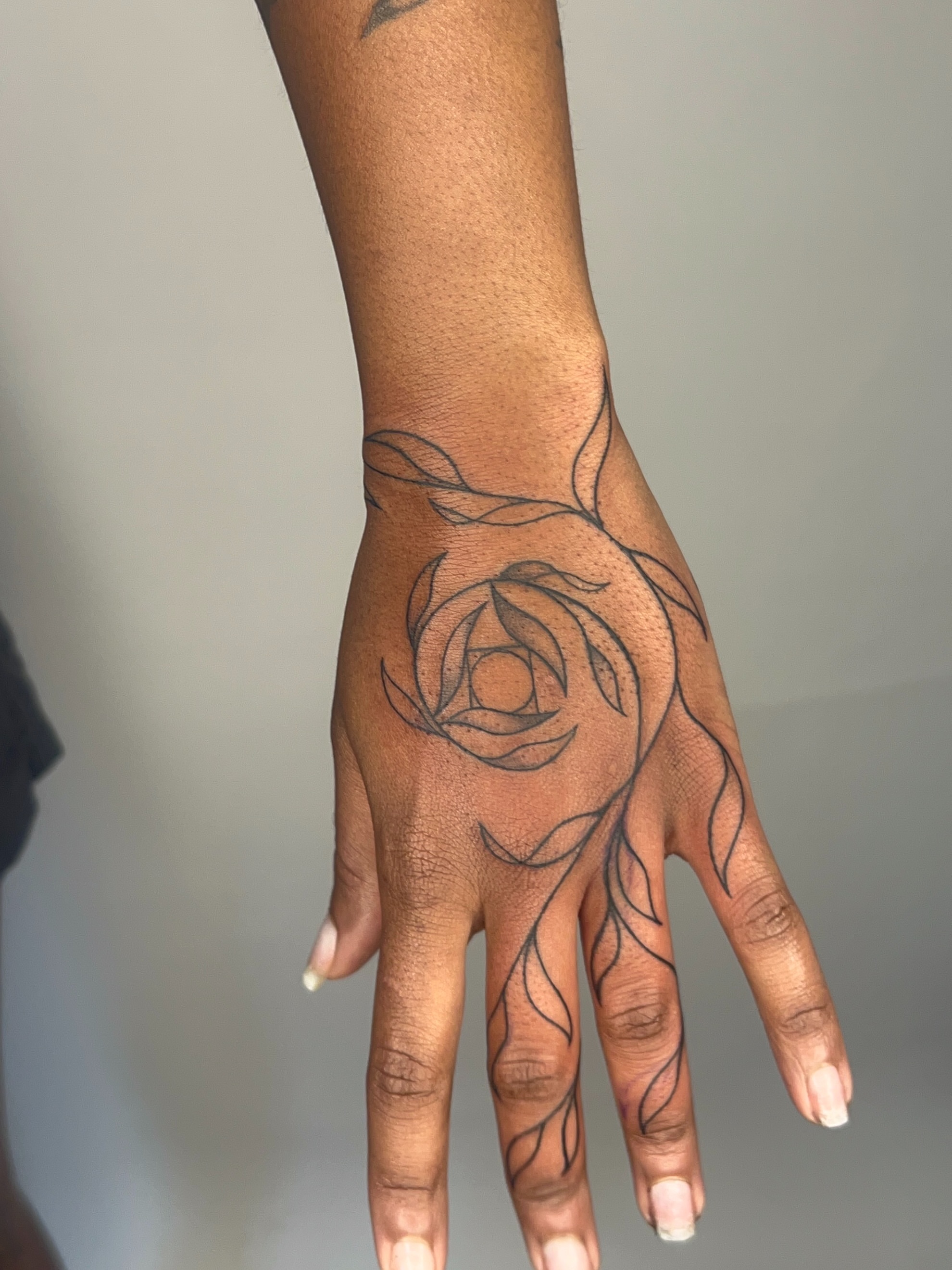 Rose black and grey tattoo on the hand by ༻𝐓𝐡𝐞 𝐒𝐤𝐢𝐧 𝐆𝐚𝐫𝐝𝐞𝐧༺
