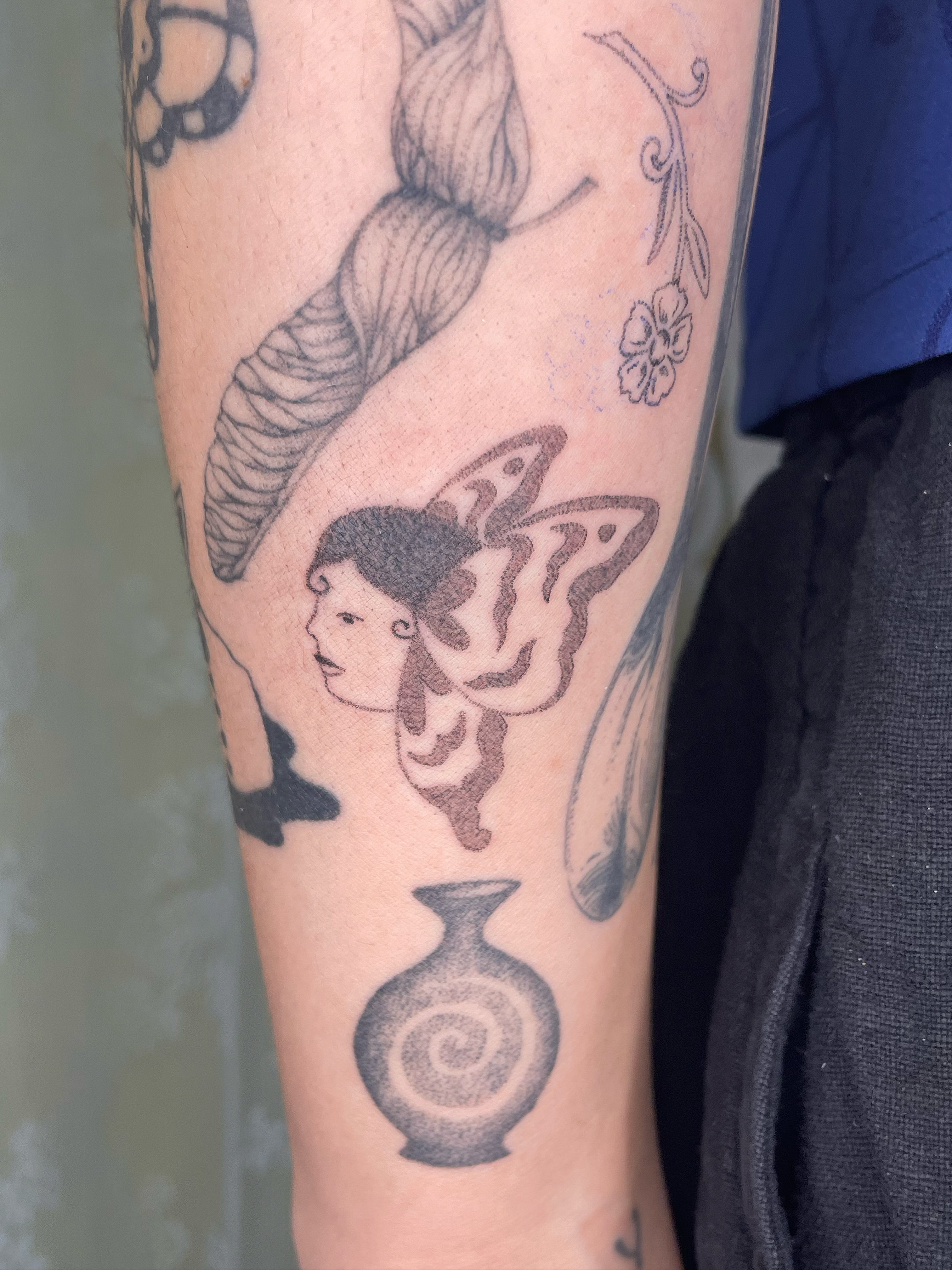 Fairy with butterfly wings black and grey tattoo on the forearm by cait