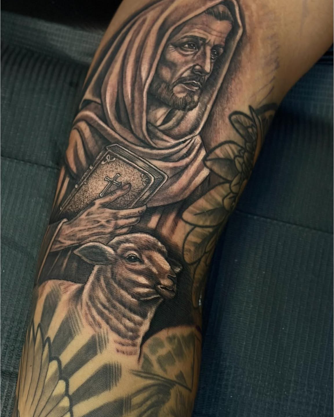 Religious figure with lamb realism tattoo on the forearm by Joel Ortiz Ginorio