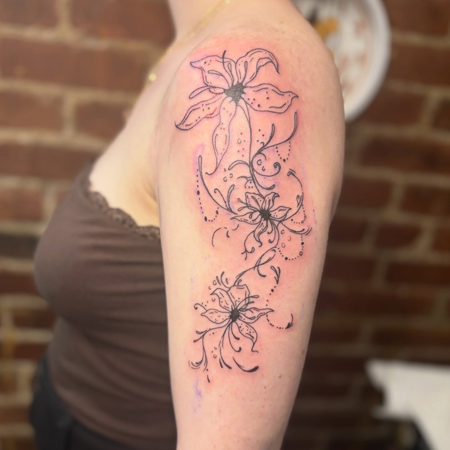 Flowers dotwork tattoo on the upper arm by Casey - Tattooer, Salem, Massachusetts