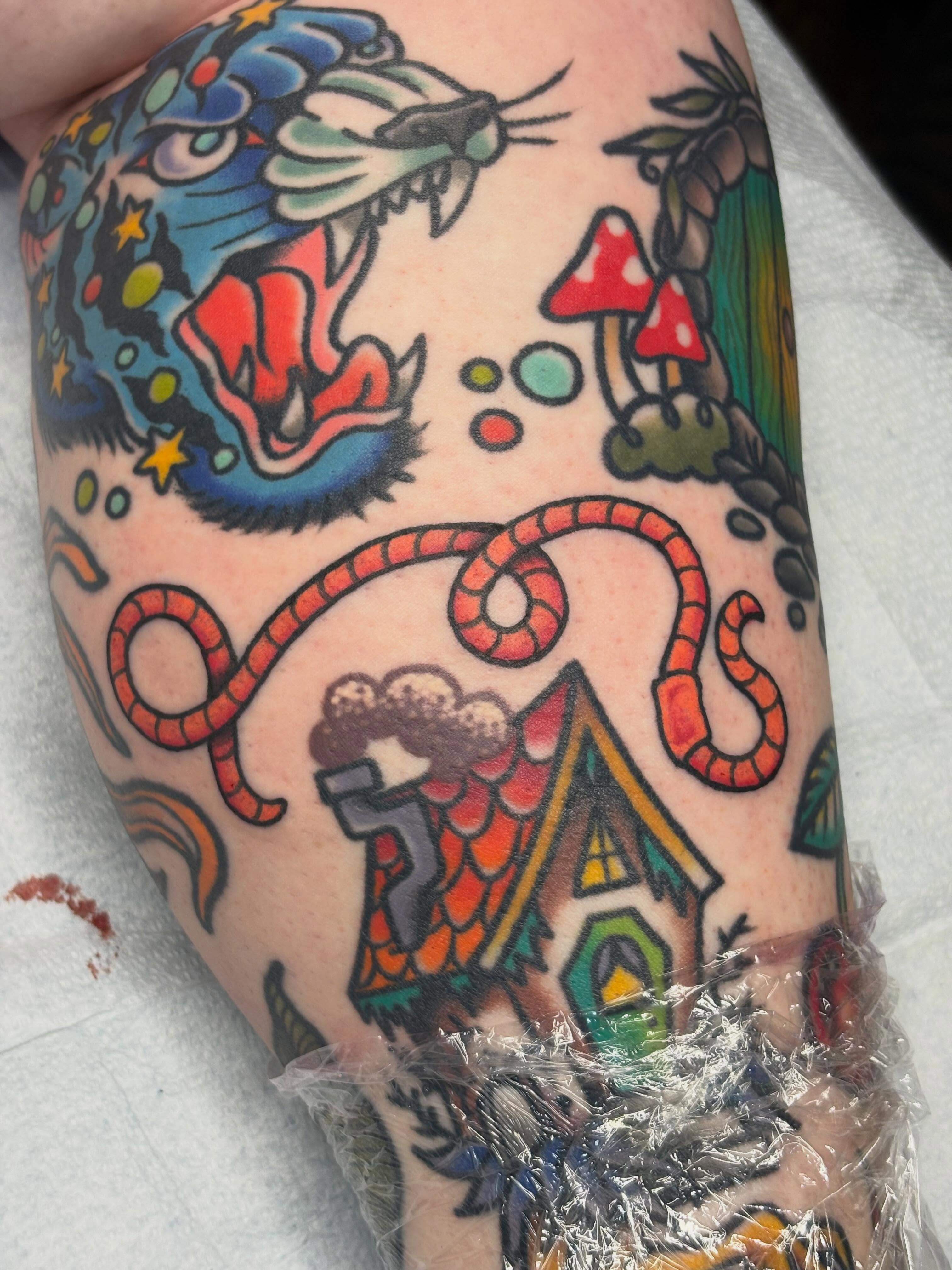 Fantasy house and snake American traditional tattoo on the forearm by Sydney Pflaumer