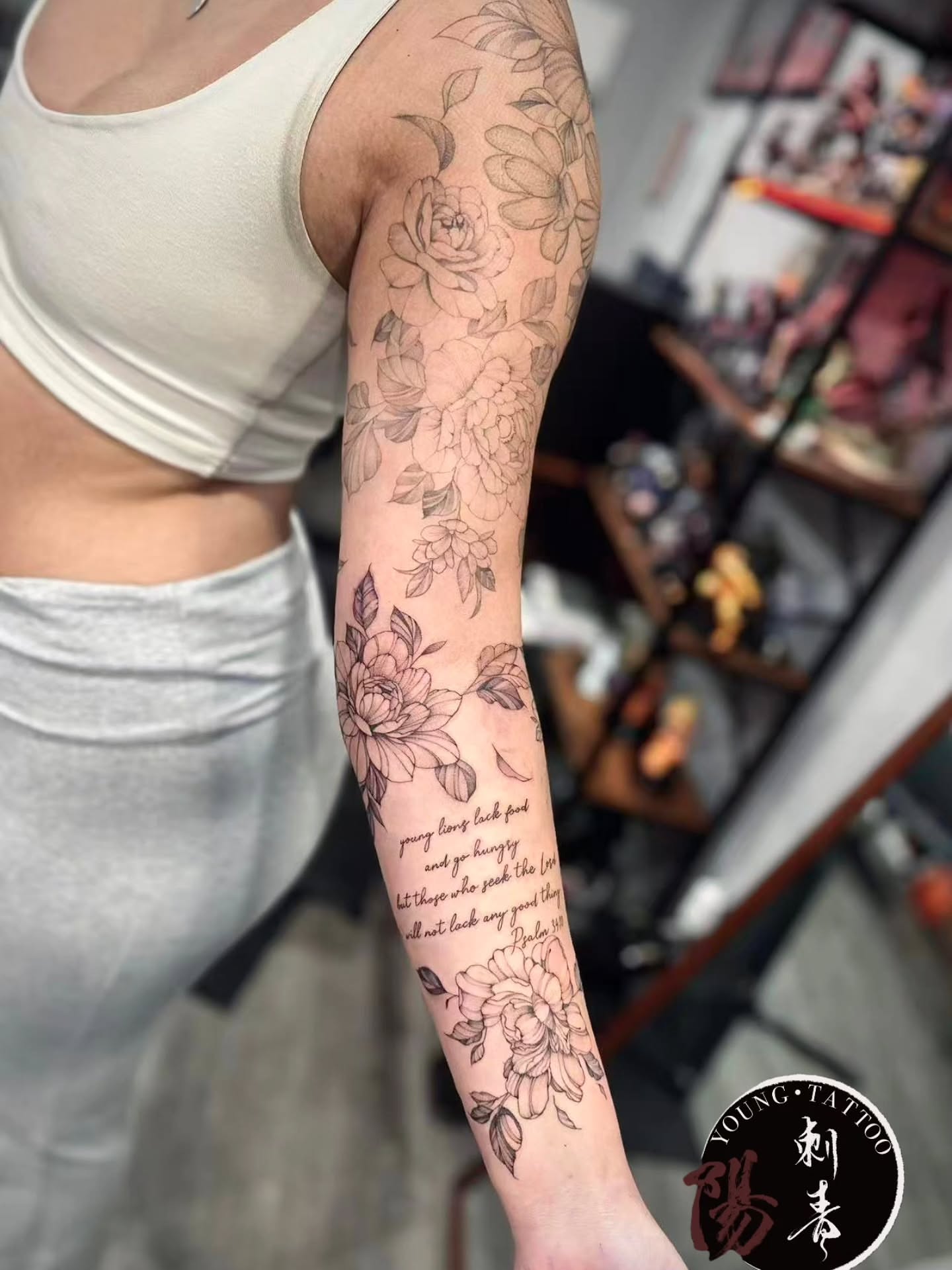 Floral bouquet black and grey tattoo on the forearm by Ying