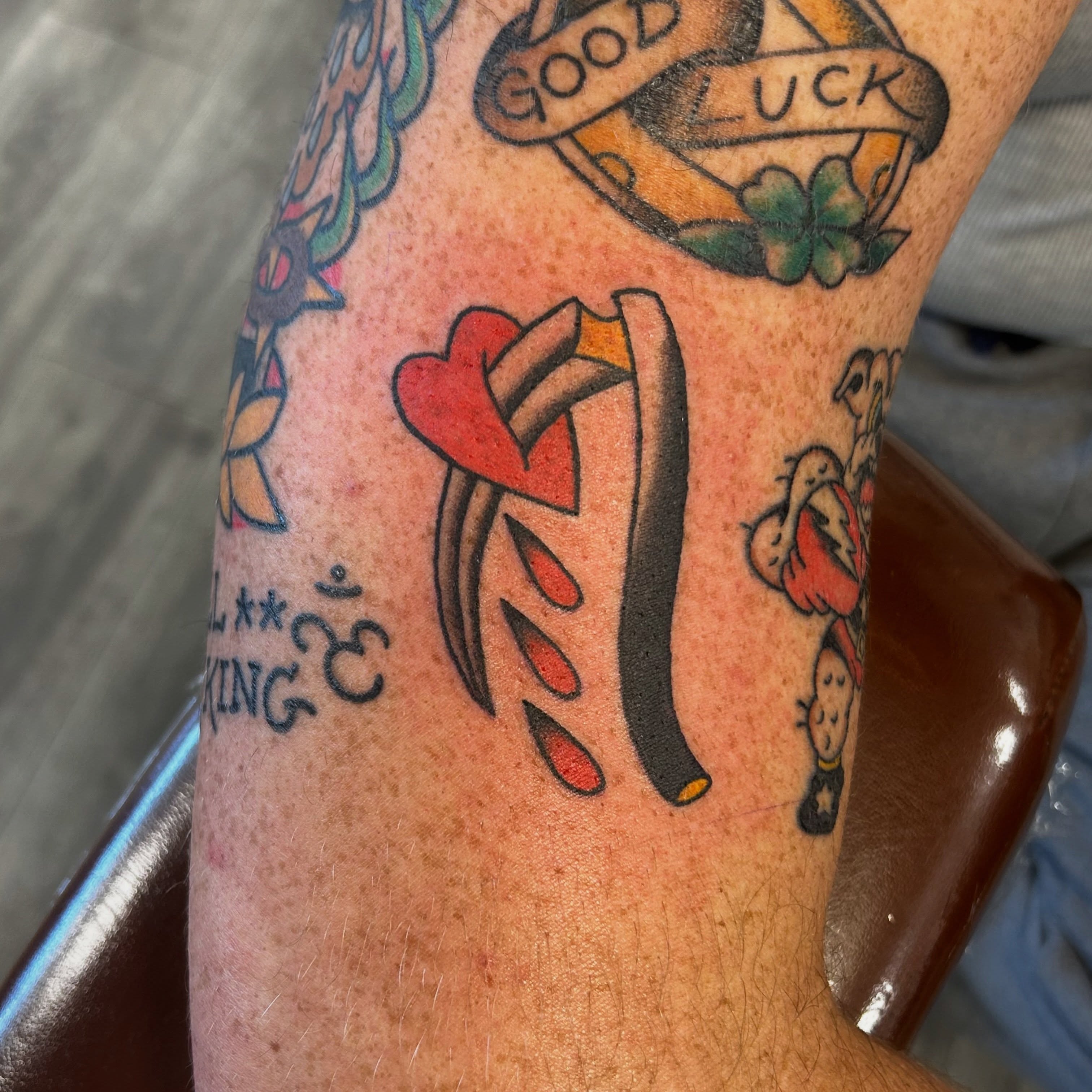 Heart and dagger American traditional tattoo on the forearm by Tawni Bender