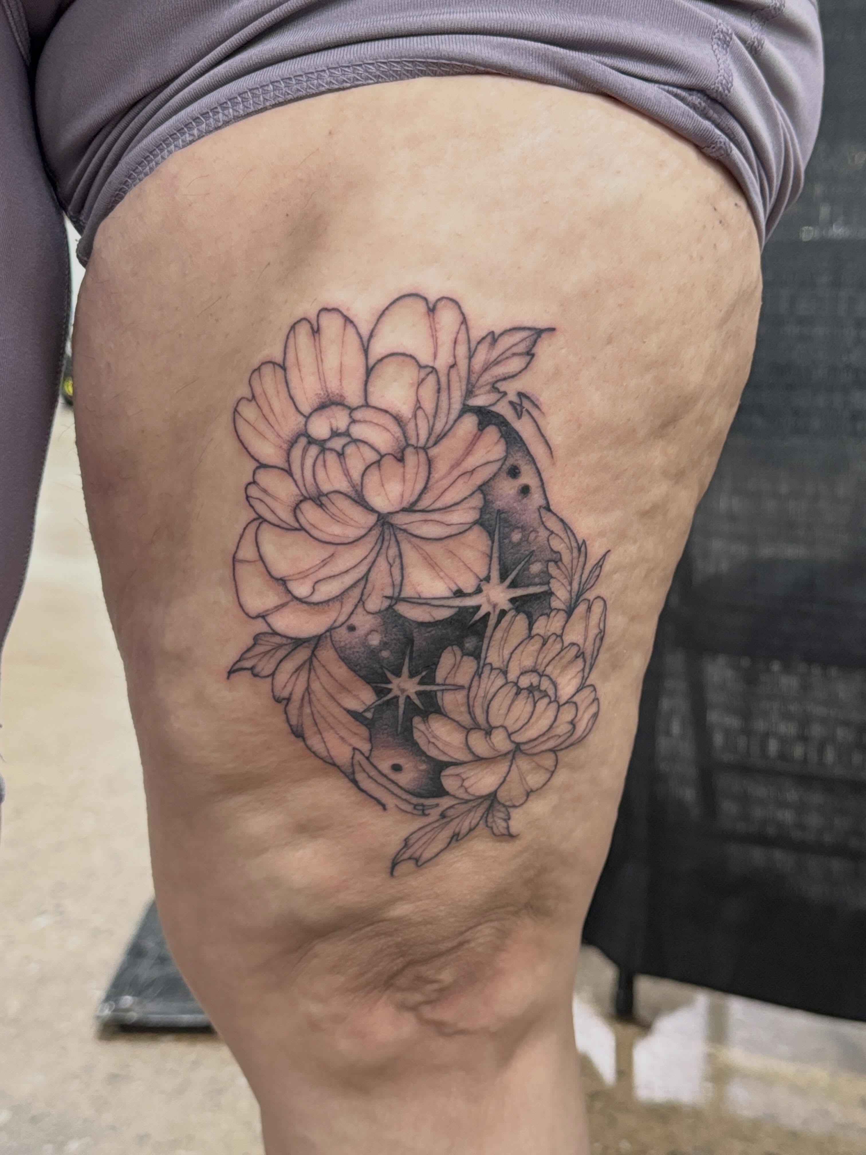 Peony flowers and stars black and grey tattoo on the thigh by Rebecca Rose