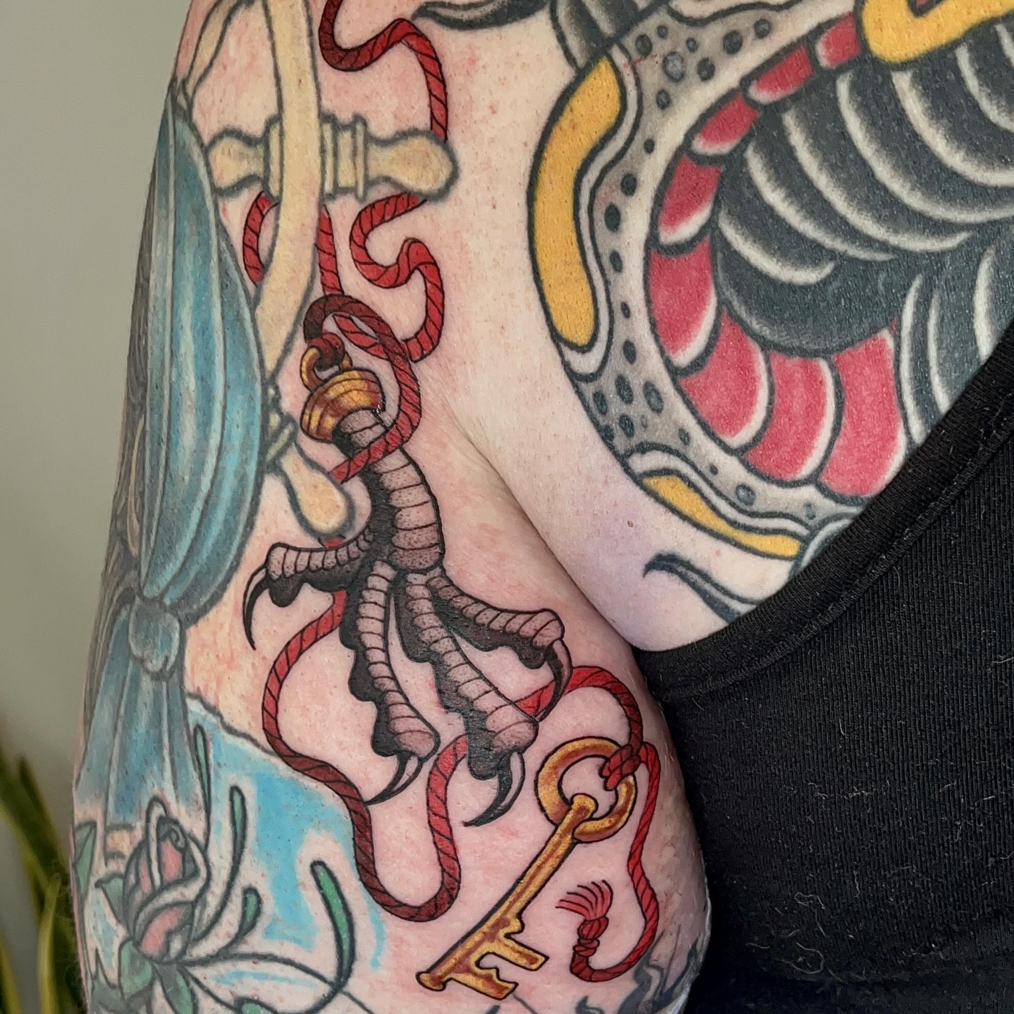 Key and rope American traditional tattoo on the upper arm by Samantha Castrovinci, Durham, North Carolina