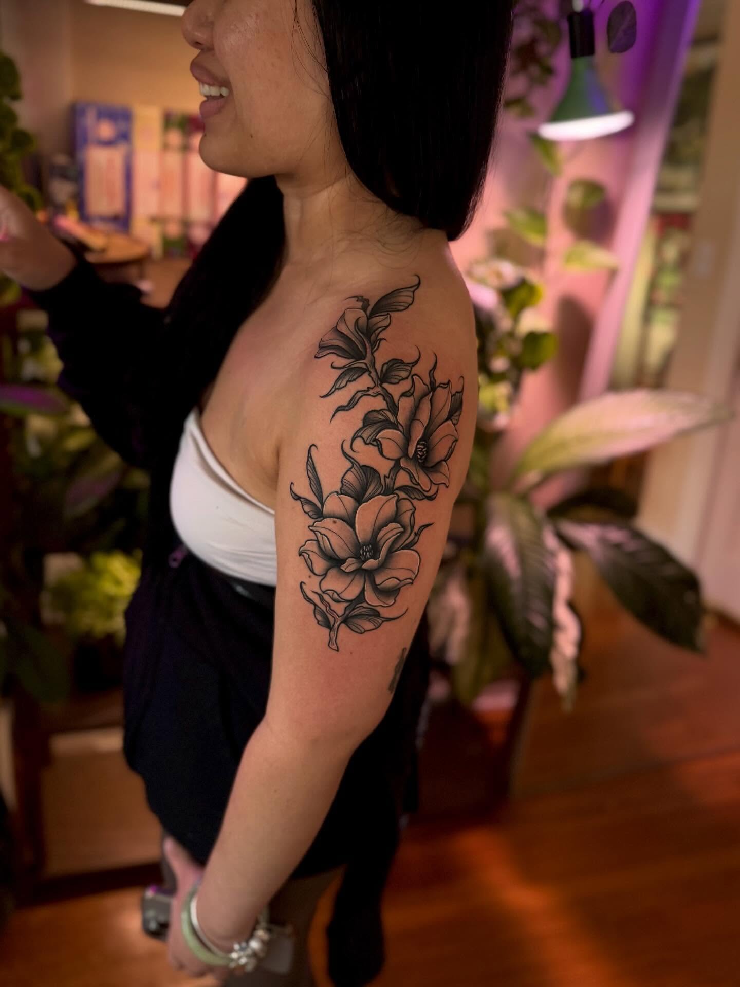 Floral arrangement black and grey tattoo on the shoulder by Angie Cotton