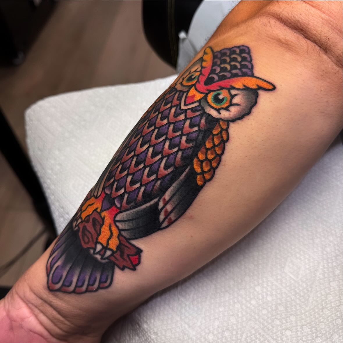 Owl wearing hat American traditional tattoo on the forearm by Larry Love