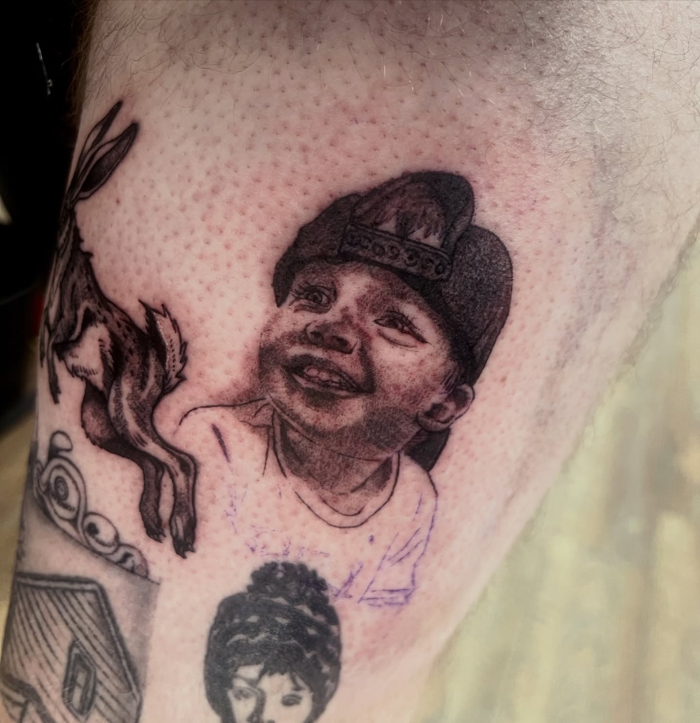 Child with cap black and grey tattoo on the forearm by Evan Intveld