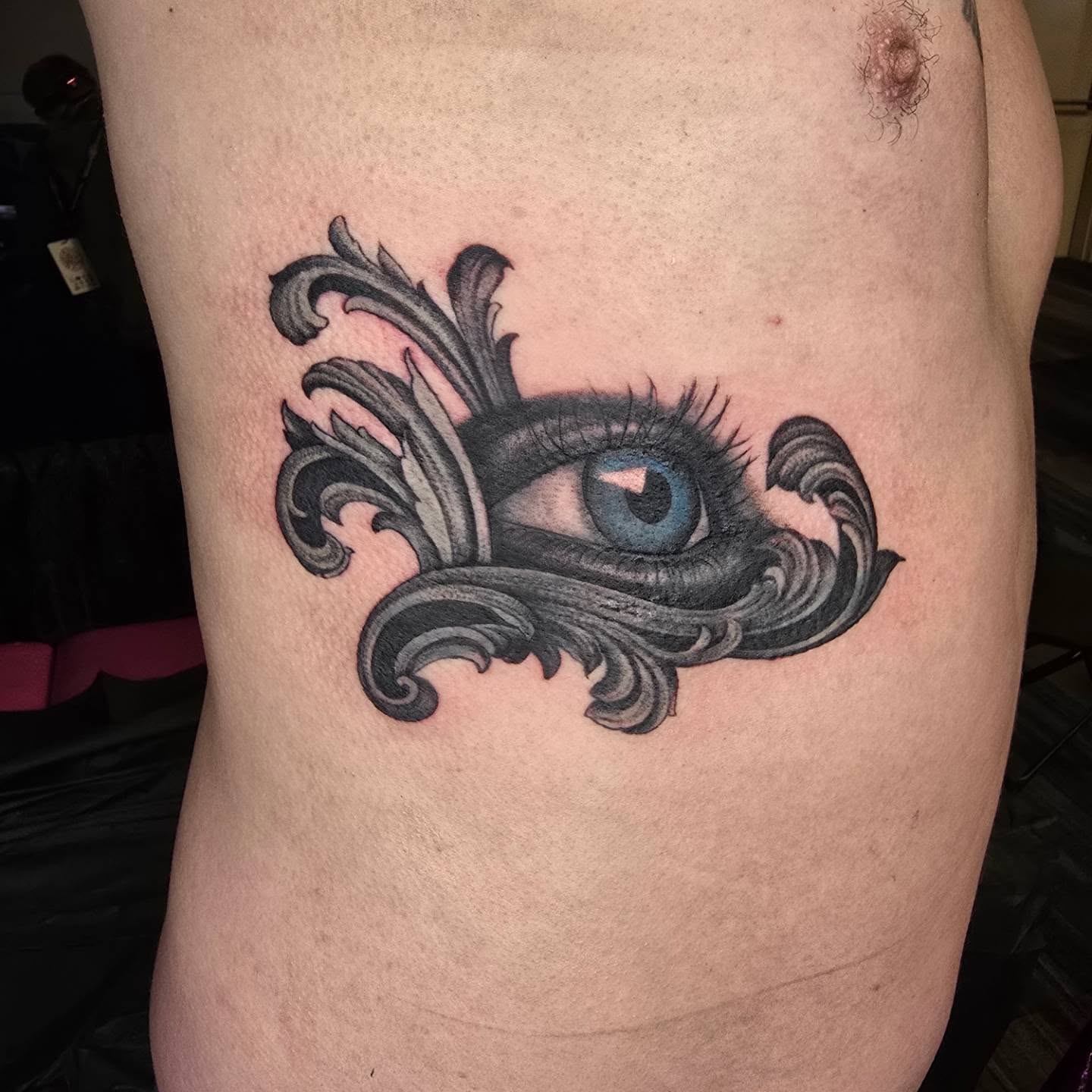 Eye with ornamental swirls ornamental tattoo on the thigh by Rachel, Centereach, New York