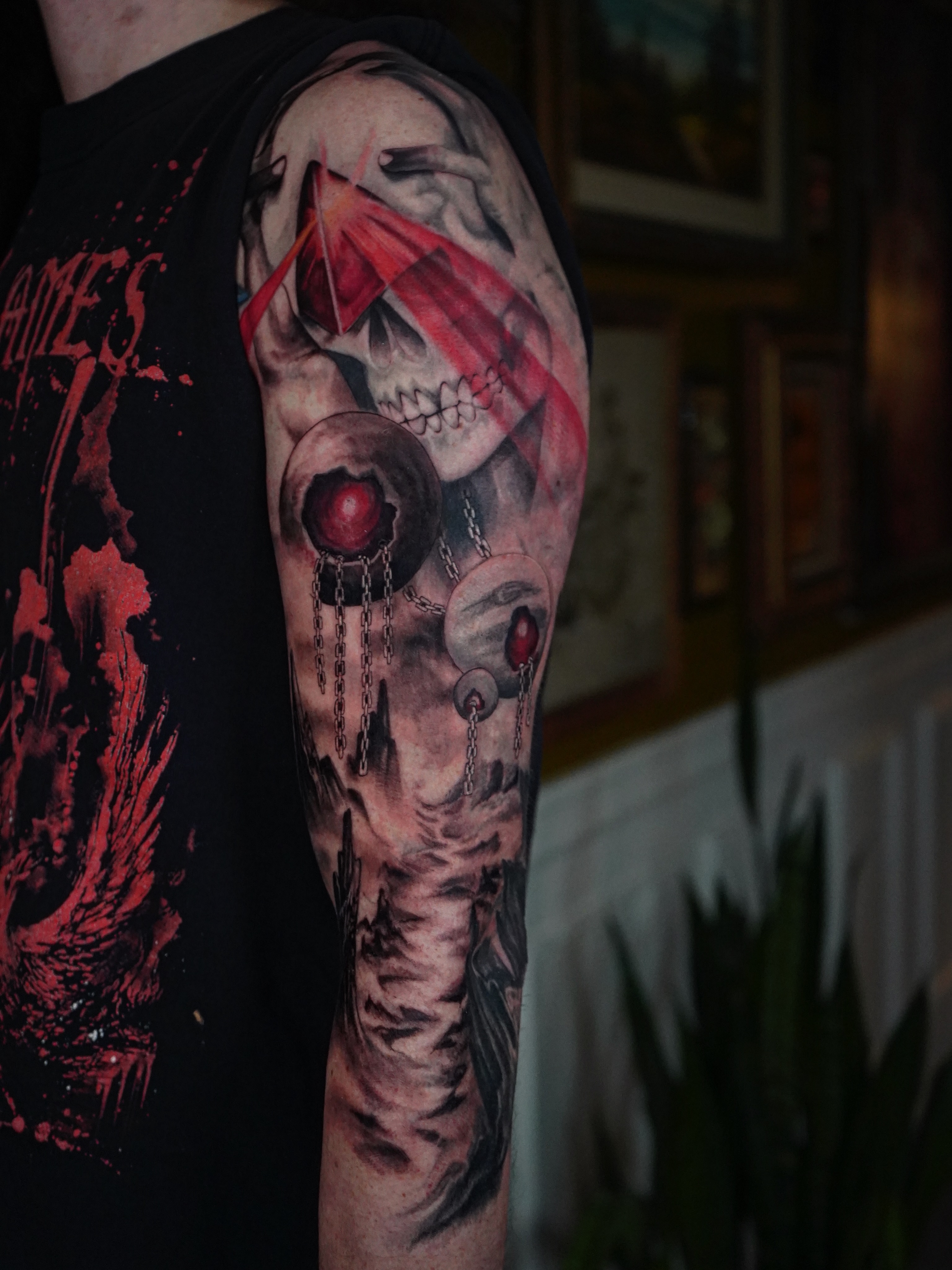 Skull and chains realism tattoo on the upper arm by Sunny Sunseri