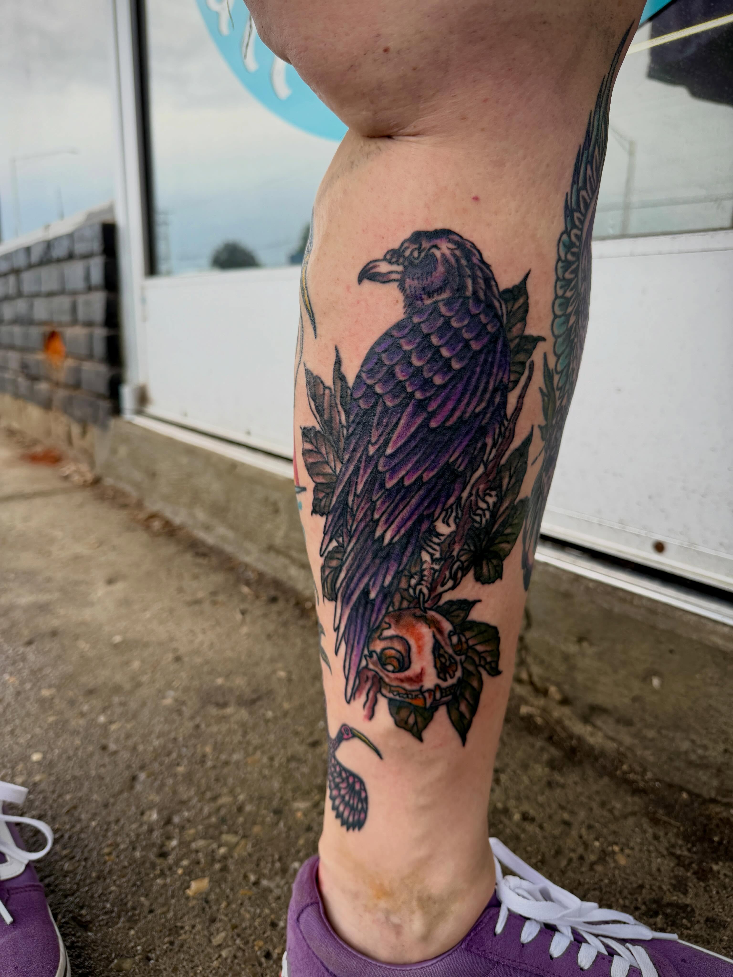 Crow and rose realism tattoo on the forearm by Ali Calis