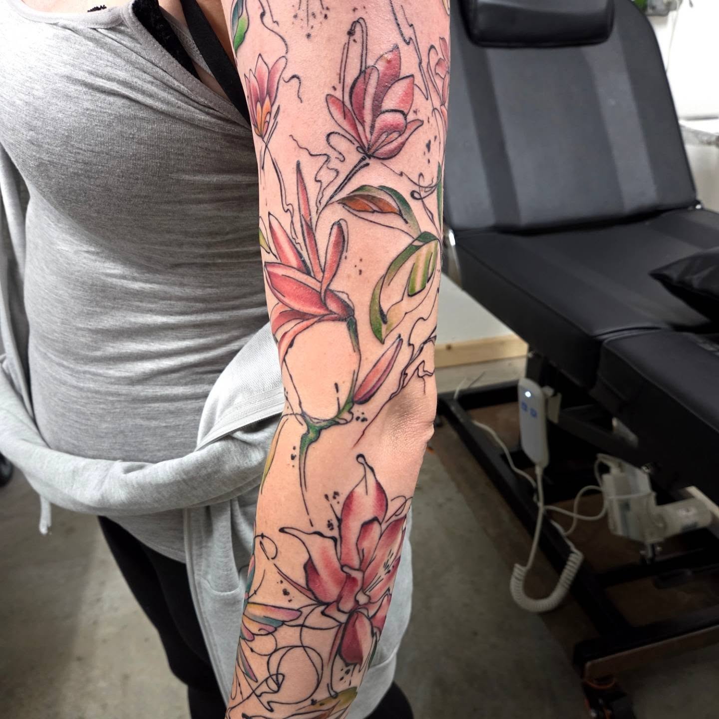 Lilies watercolor tattoo on the forearm by Ashley