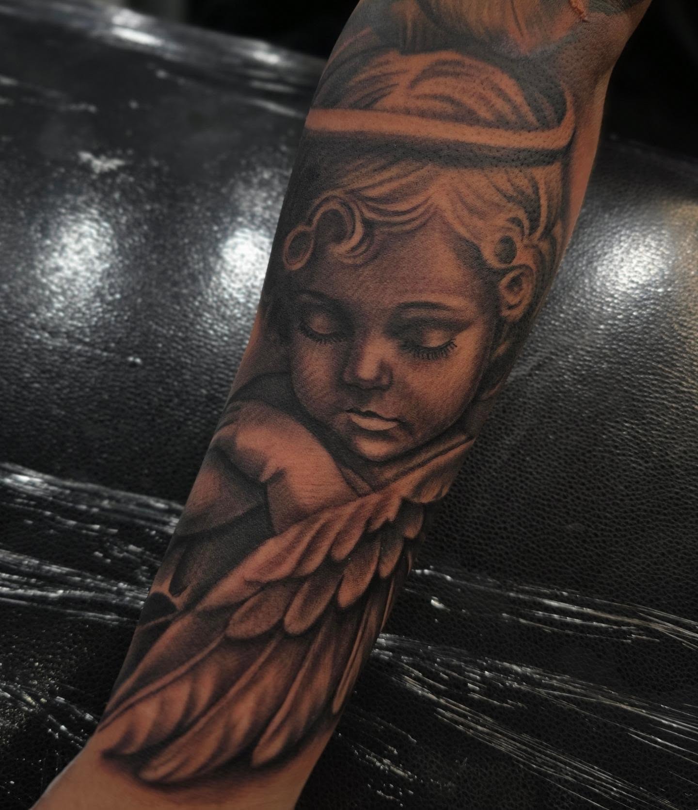 Angel realism tattoo on the forearm by Richie Garcia, Hesperia, California
