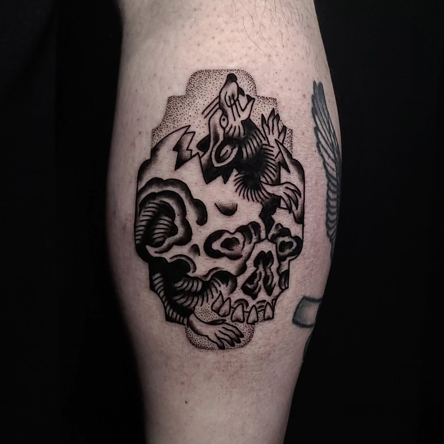 Skull with dragon dotwork tattoo on the forearm by Alex Stairs