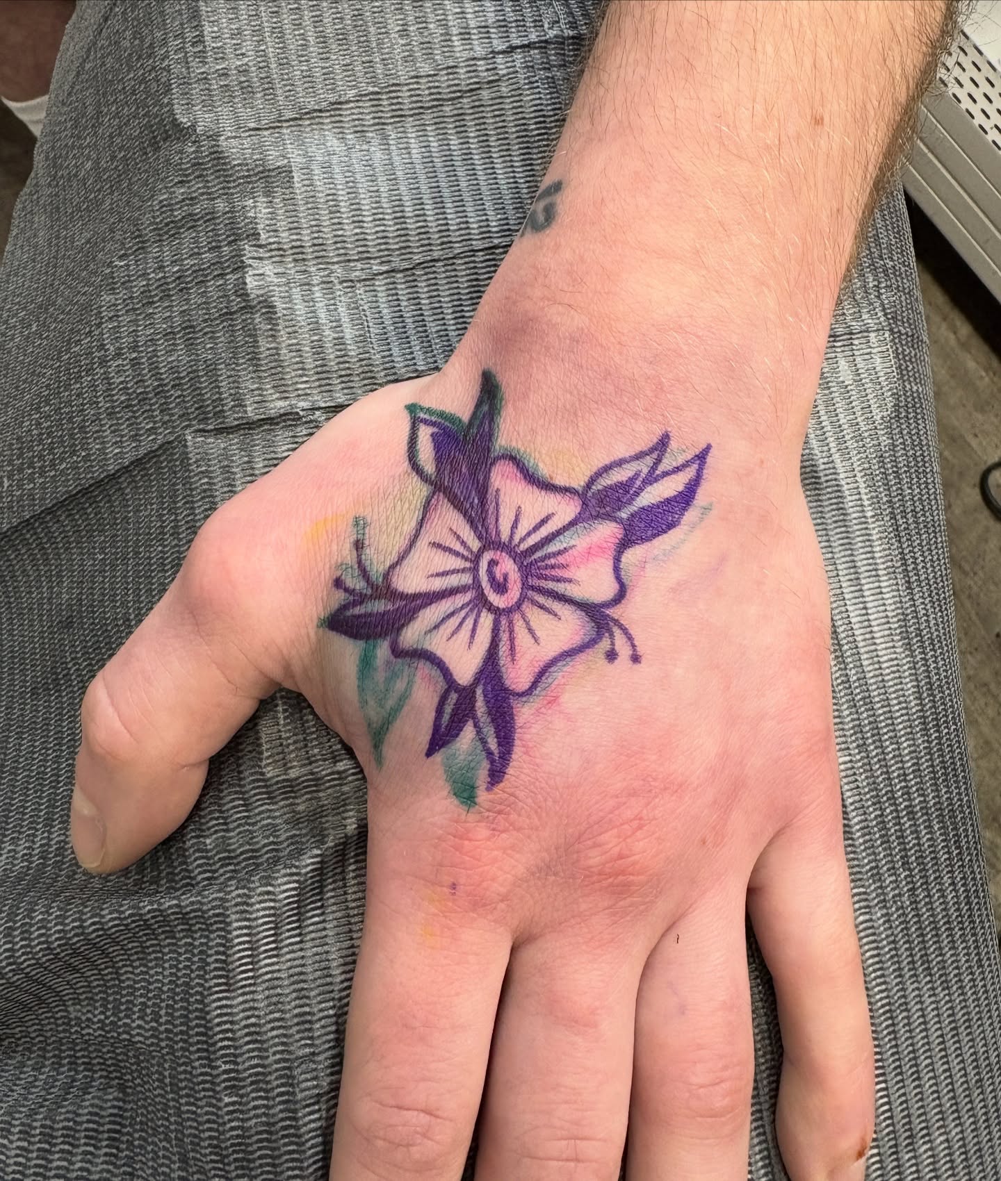 Flower watercolor tattoo on the hand by Casey - Tattooer, Salem, Massachusetts