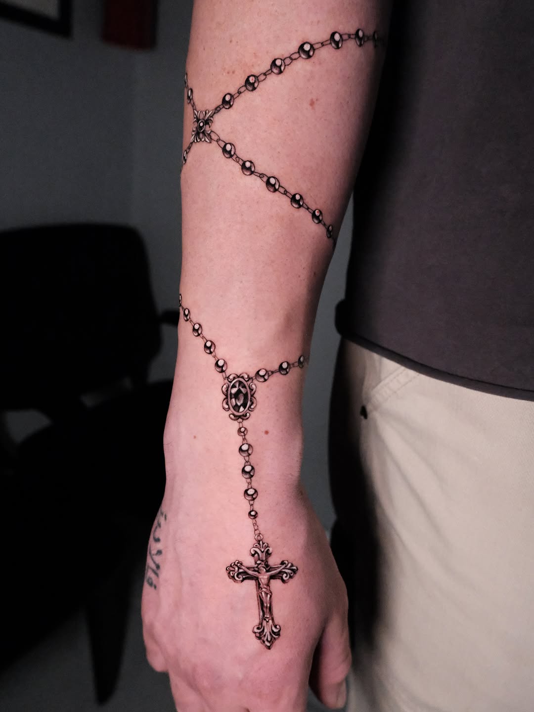 Rosary beads and crucifix lettering tattoo on the forearm by Bay Area Tattoo Artist