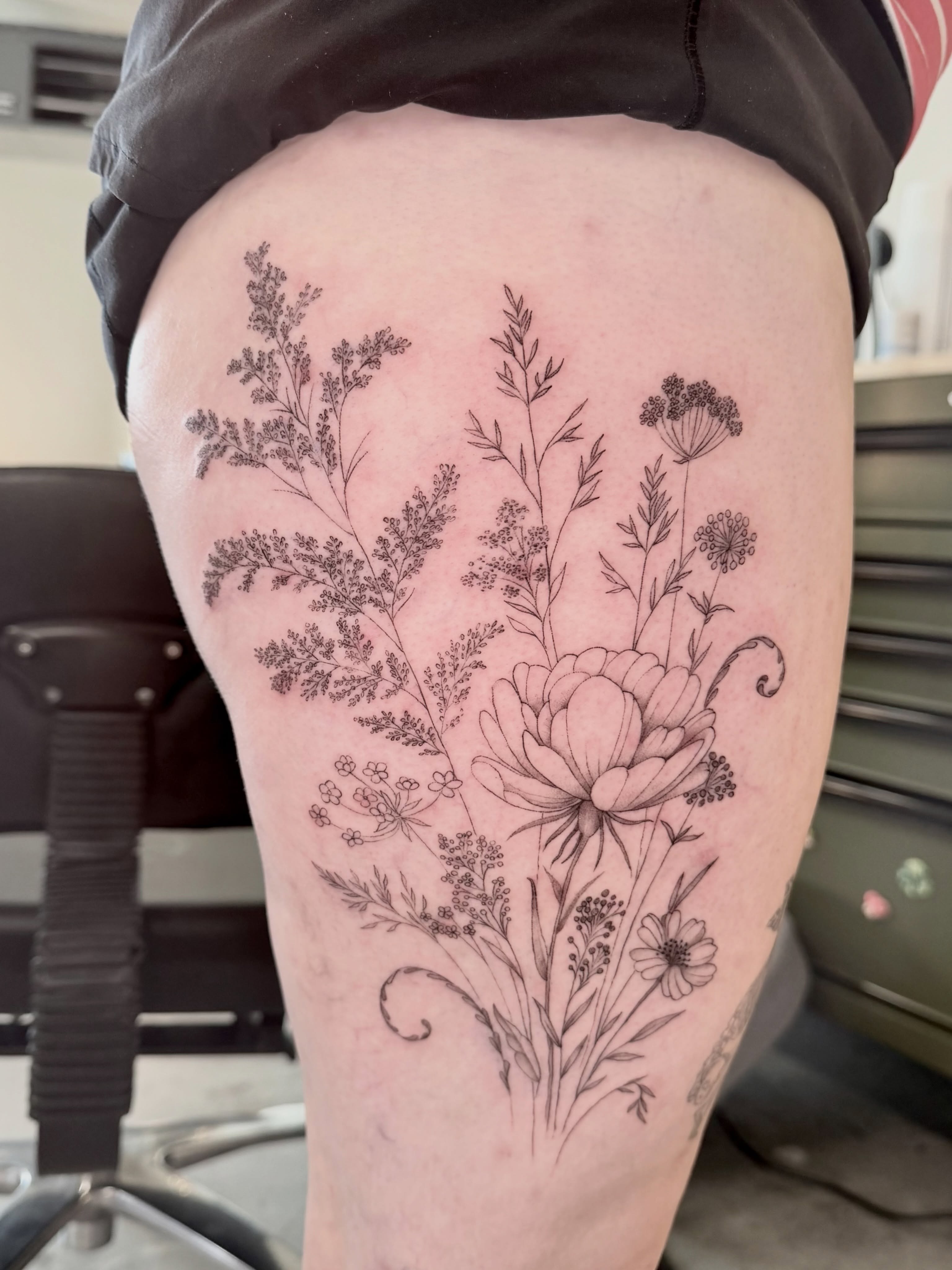 Floral bouquet realism tattoo on the thigh by Anna