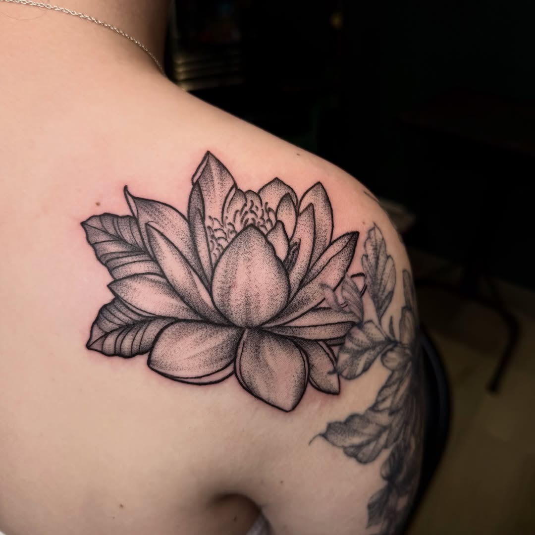 Lotus flower dotwork tattoo on the shoulder by Jennifer Contreras