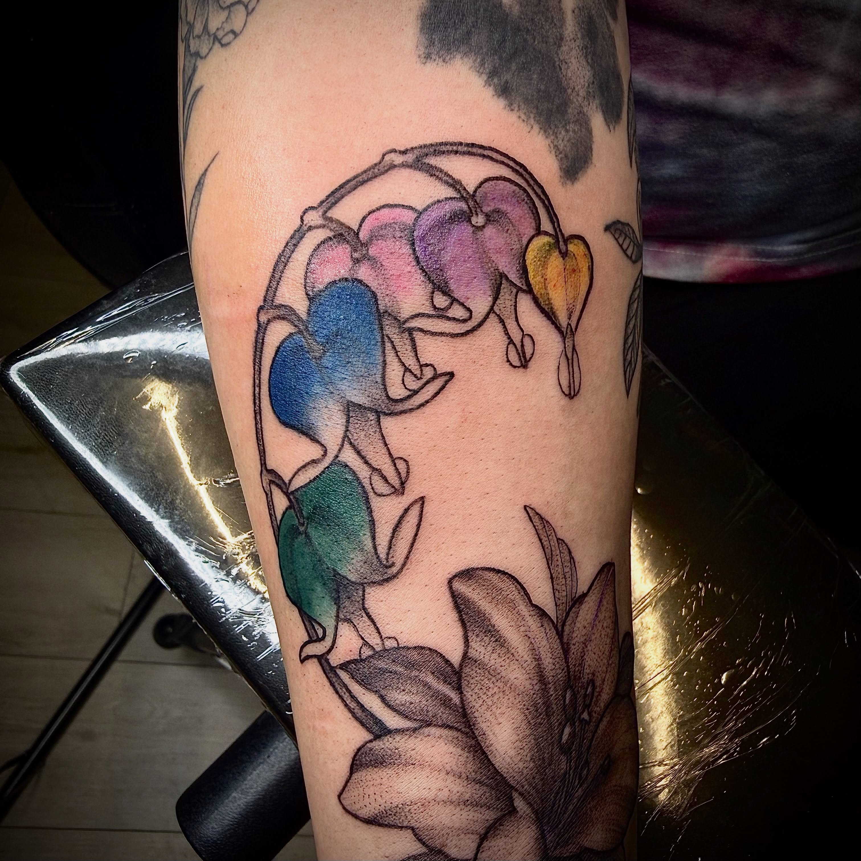 Flower and hearts watercolor tattoo on the forearm by Jennifer Contreras