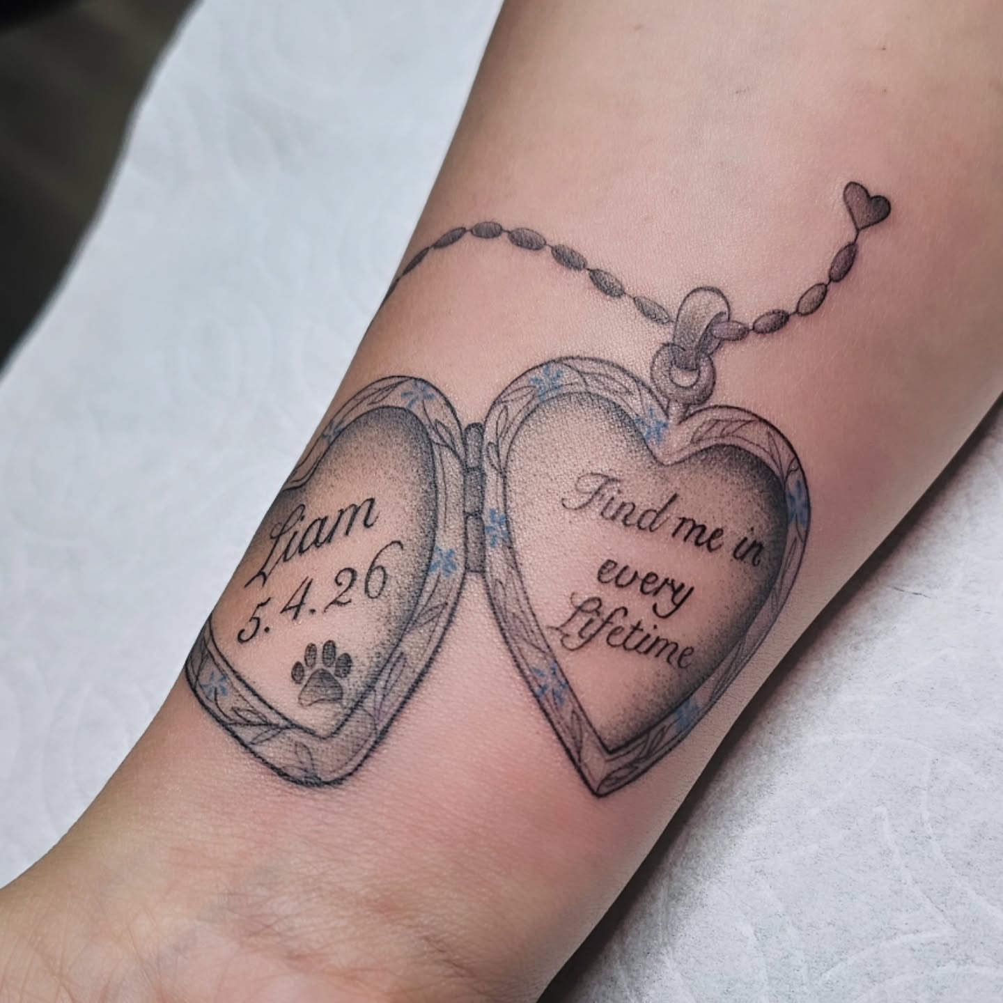 Heart locket black and grey tattoo on the forearm by Adriannah Esparza