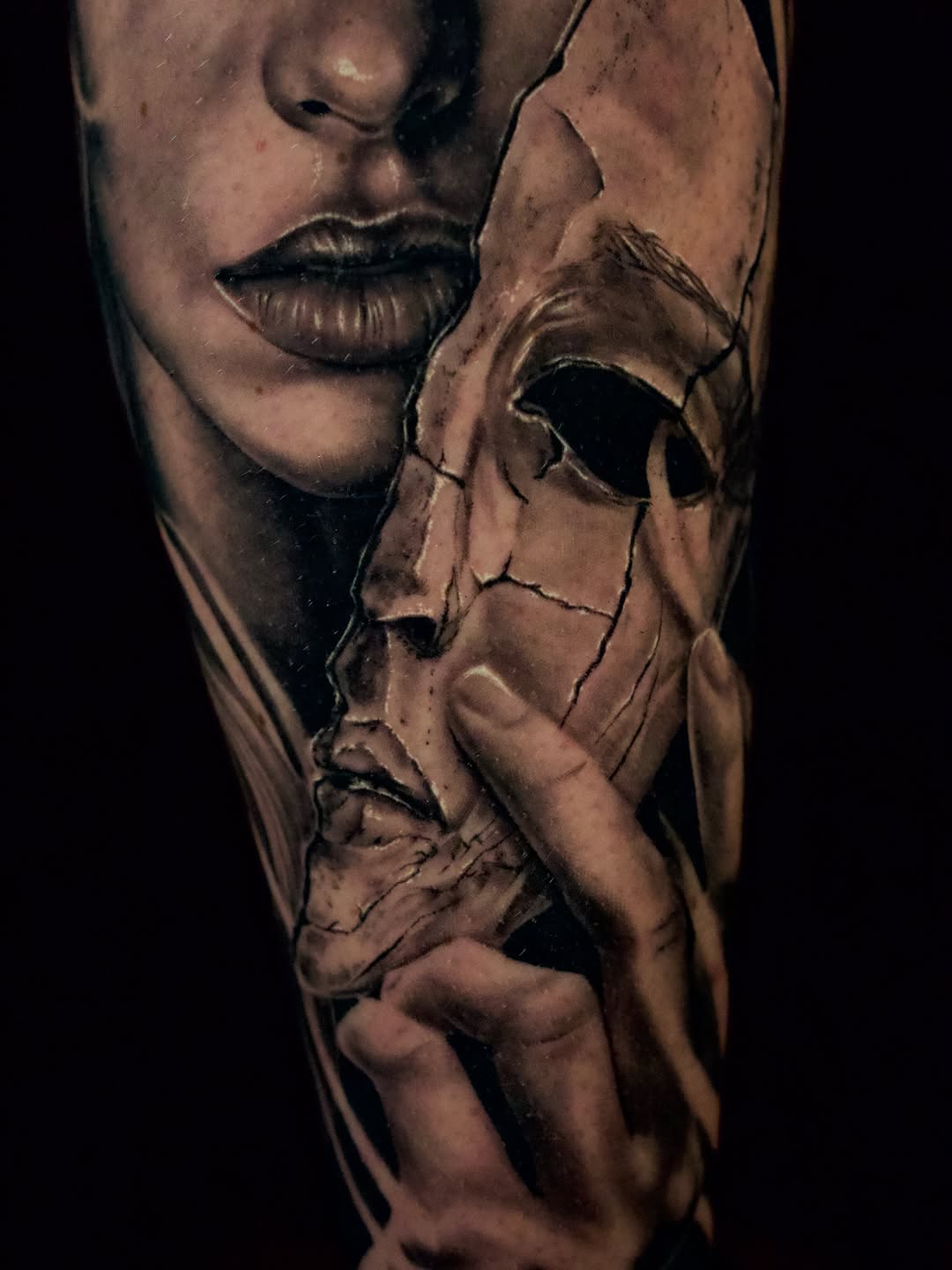 Woman's face with cracked mask realism tattoo on the forearm by April Lynn