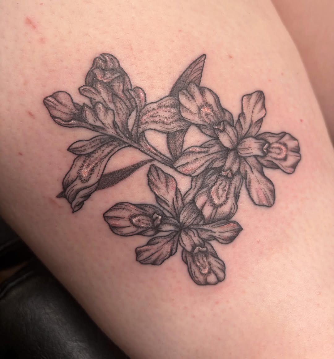 Flower cluster black and grey tattoo on the thigh by Mary Hannah Sosdian