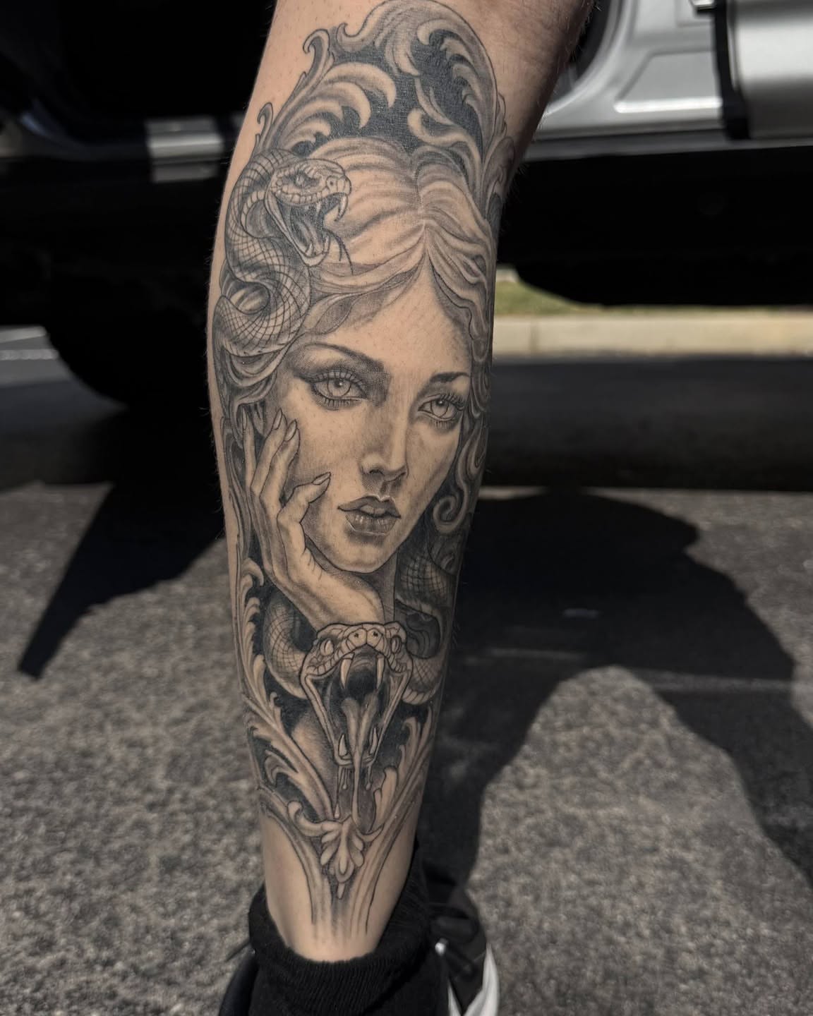 Woman with snake realism tattoo on the forearm by Danny Stewart