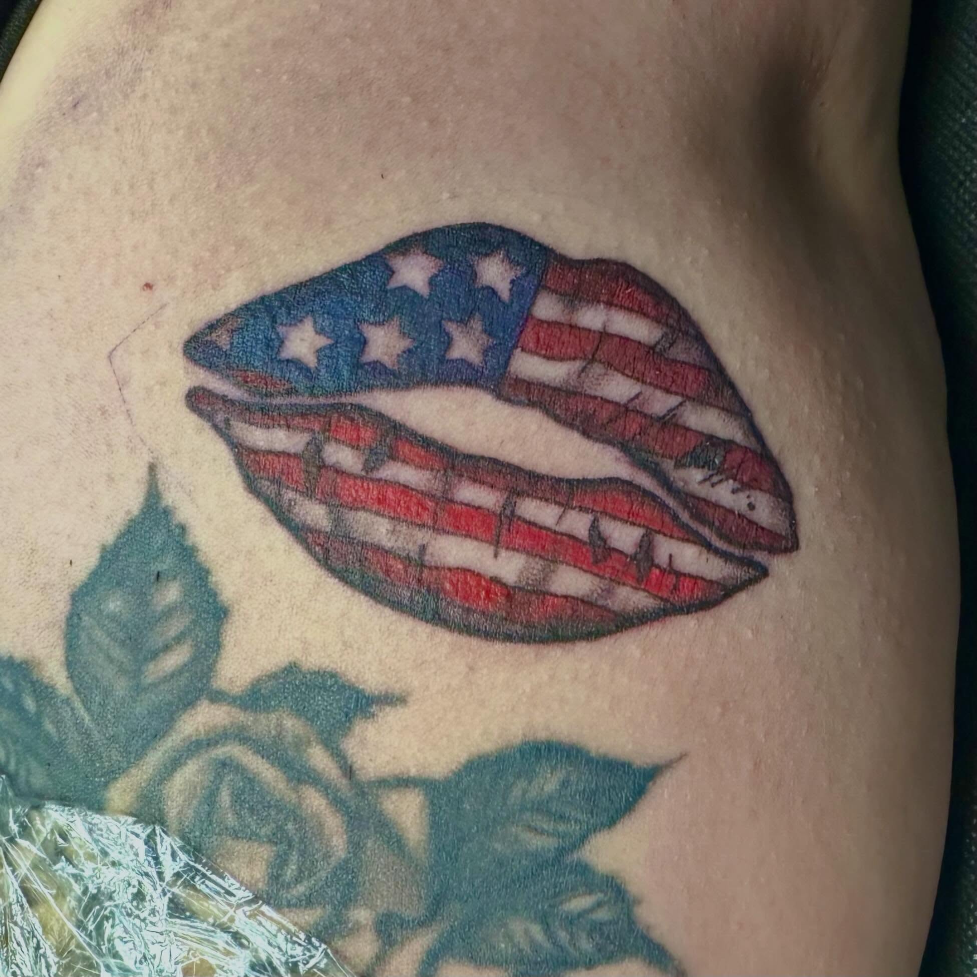 American flag lips American traditional tattoo on the thigh by Mikaila Jean