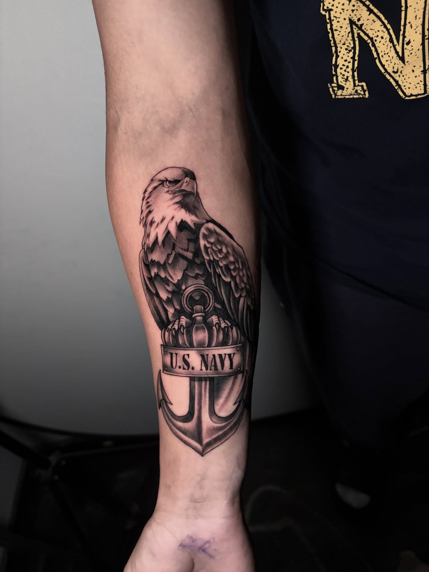 U.S. Navy eagle and anchor realism tattoo on the forearm by Morgan Martinez