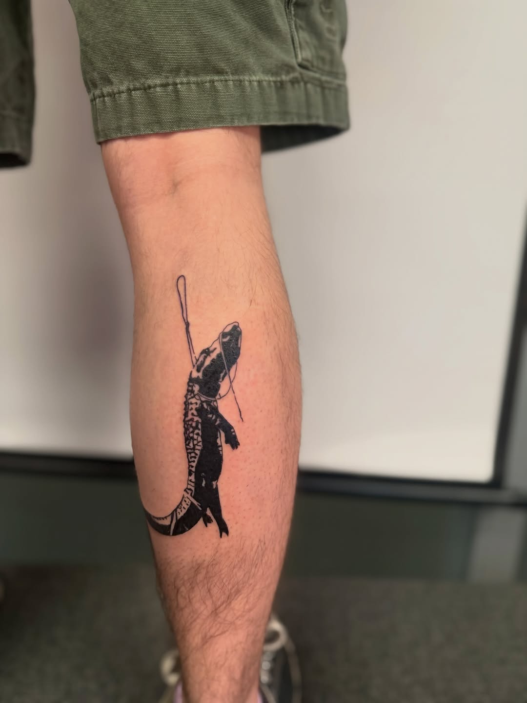 Alligator with glasses minimalist tattoo on the forearm by Alaska