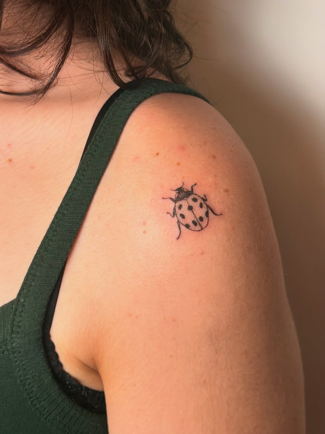 Ladybug fine line tattoo on the shoulder by Alaska