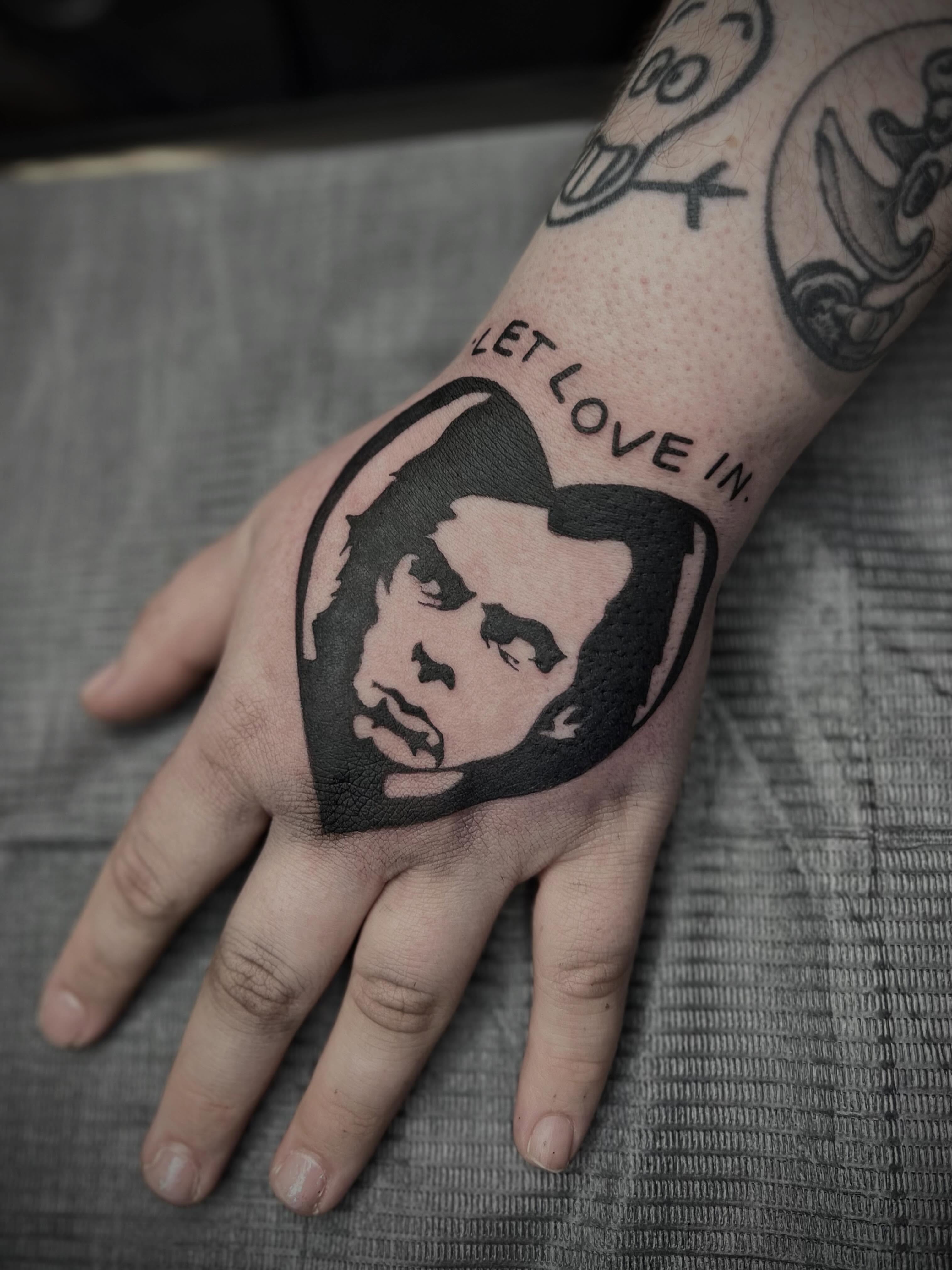 Portrait black and grey tattoo on the hand by Lexi Rose