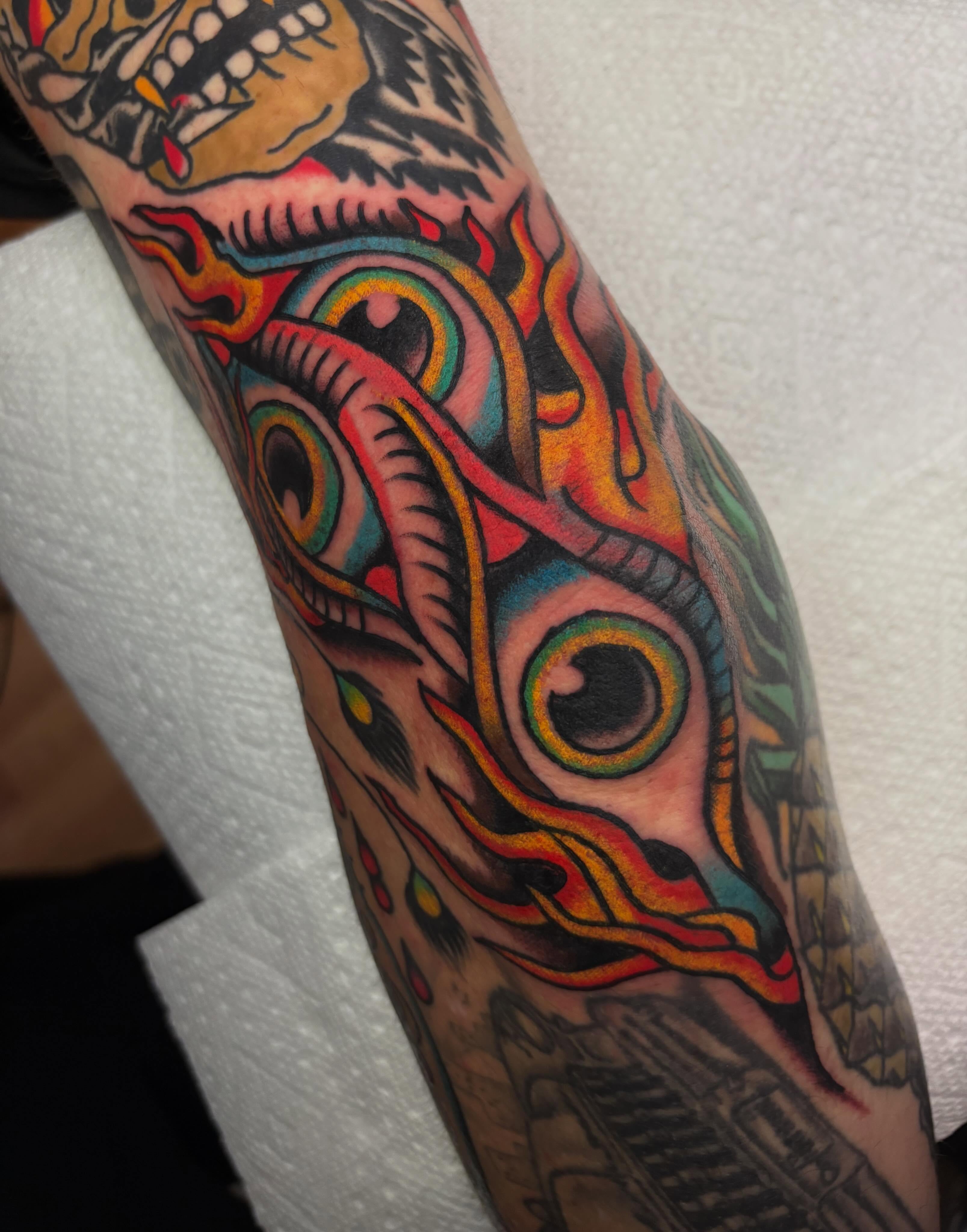 Eye with flame American traditional tattoo on the forearm by Chris Dufresne