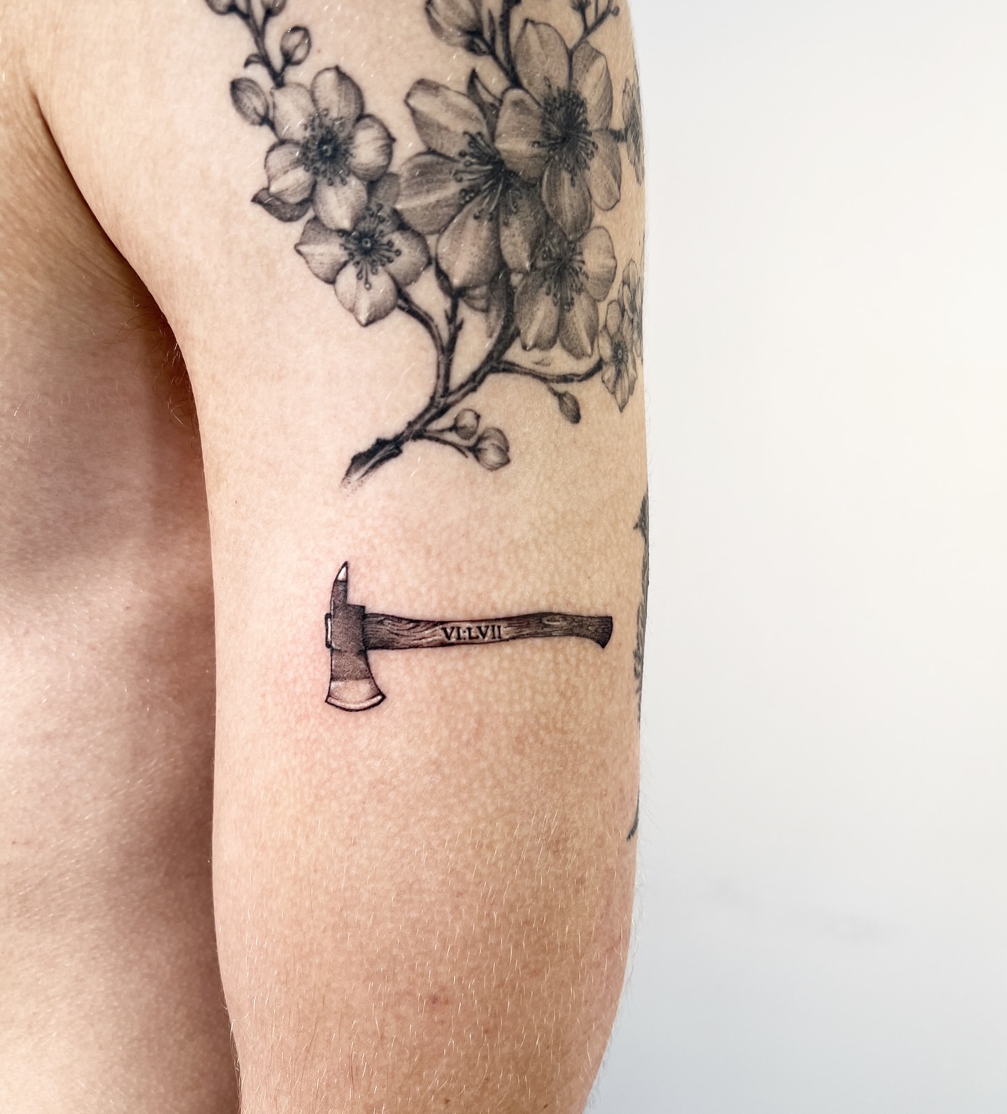 Cherry blossoms and axe realism tattoo on the forearm by ⚒dptattoos ⚒, East Williamsburg, Brooklyn
