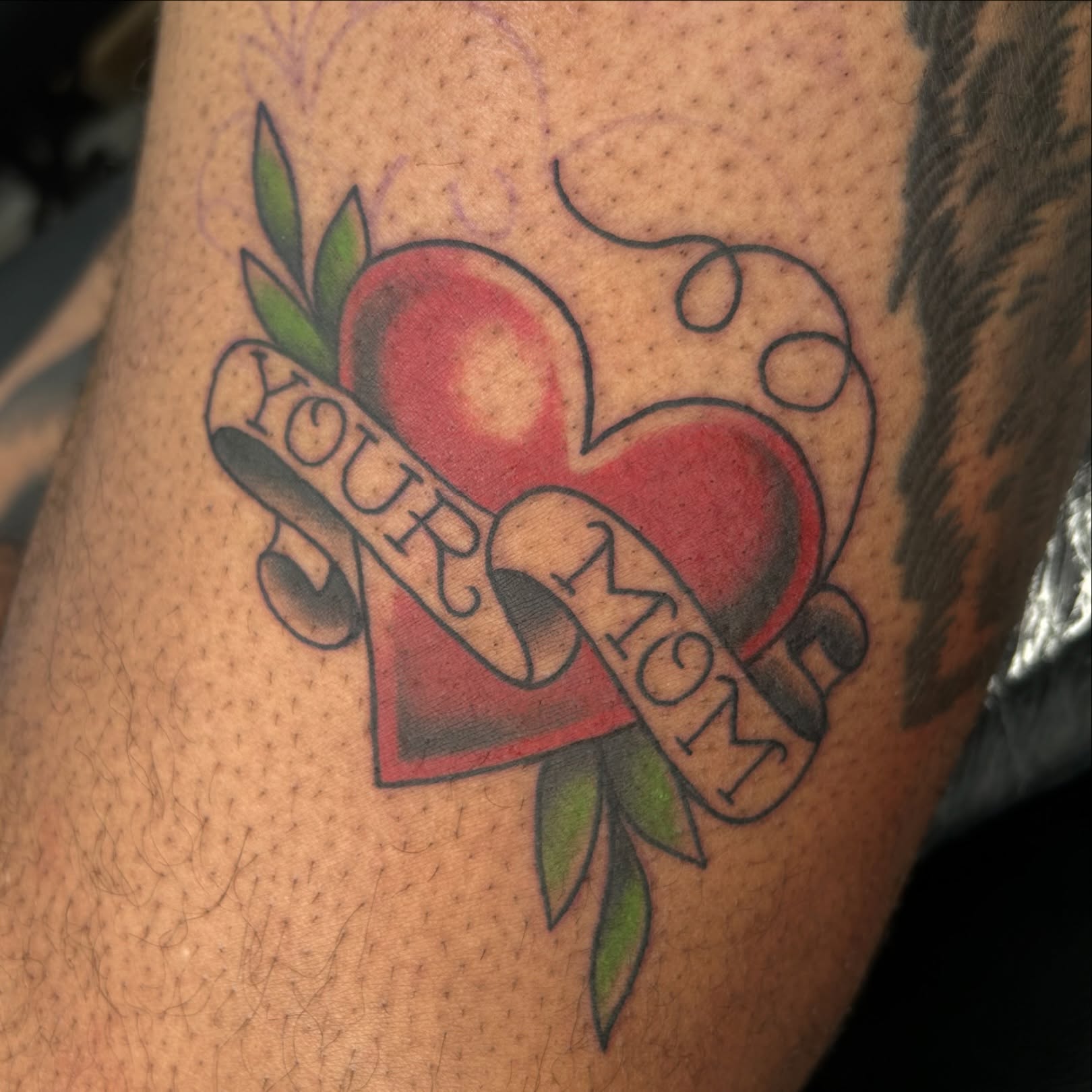 Heart with ribbon American traditional tattoo on the forearm by Audrey Migitsch