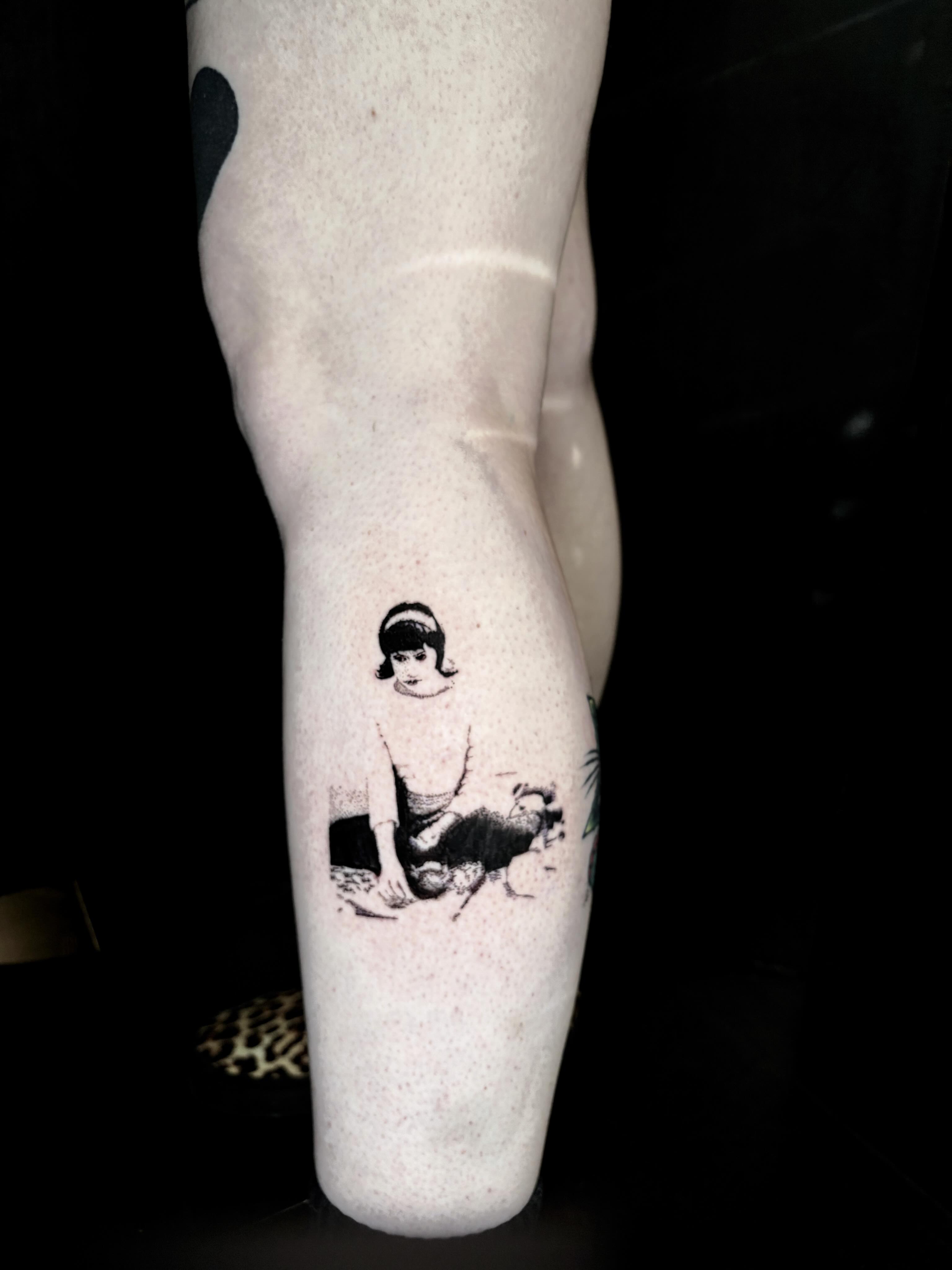 Child with bird black and grey tattoo on the forearm by Dev