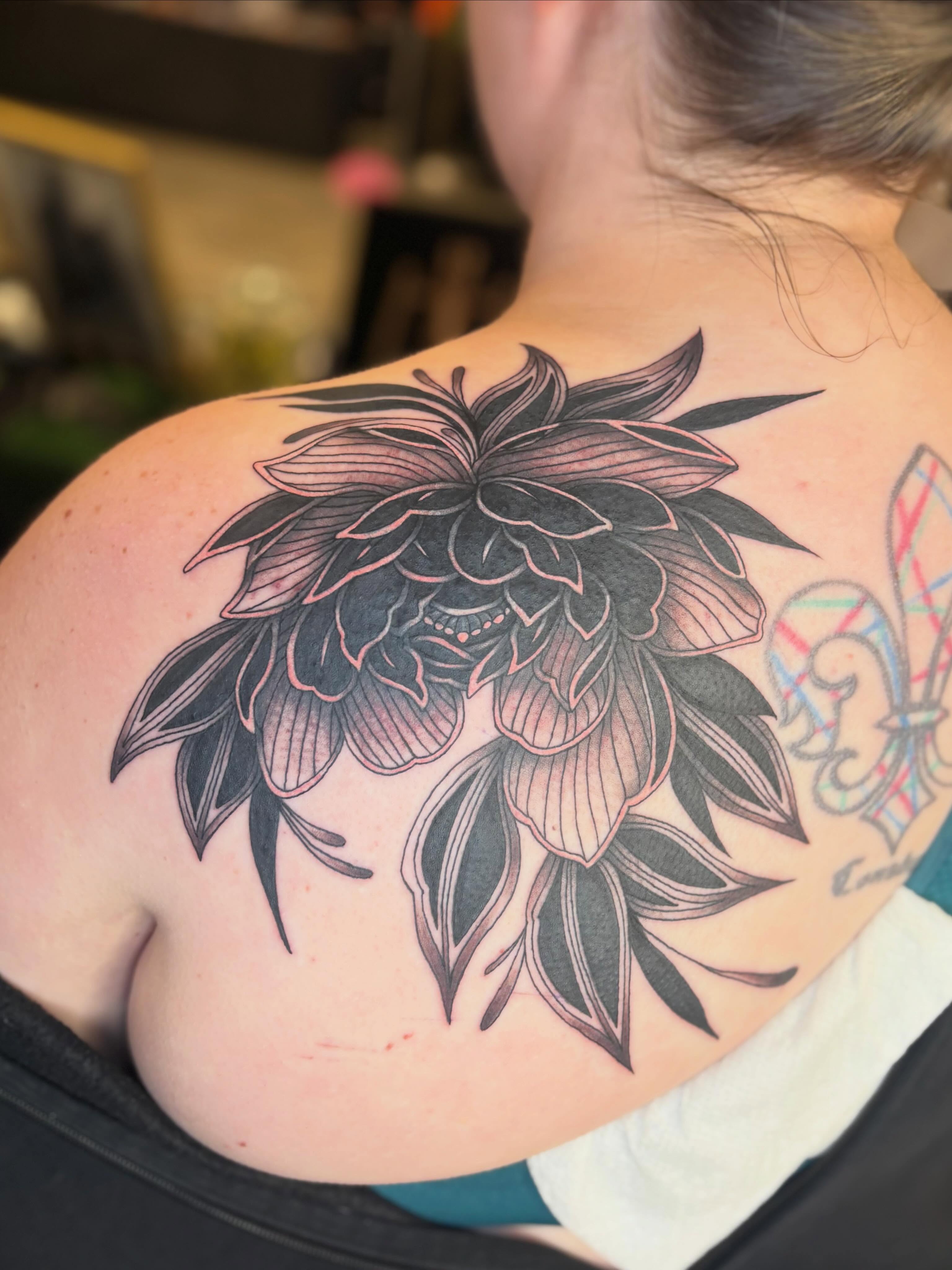 Flower black and grey tattoo on the shoulder by Olivia Buch