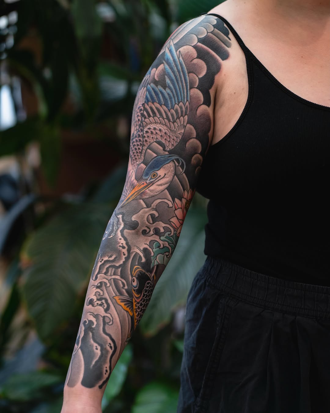 Crane and koi fish with waves Japanese tattoo on the forearm by Matt Leibo, San Francisco, California