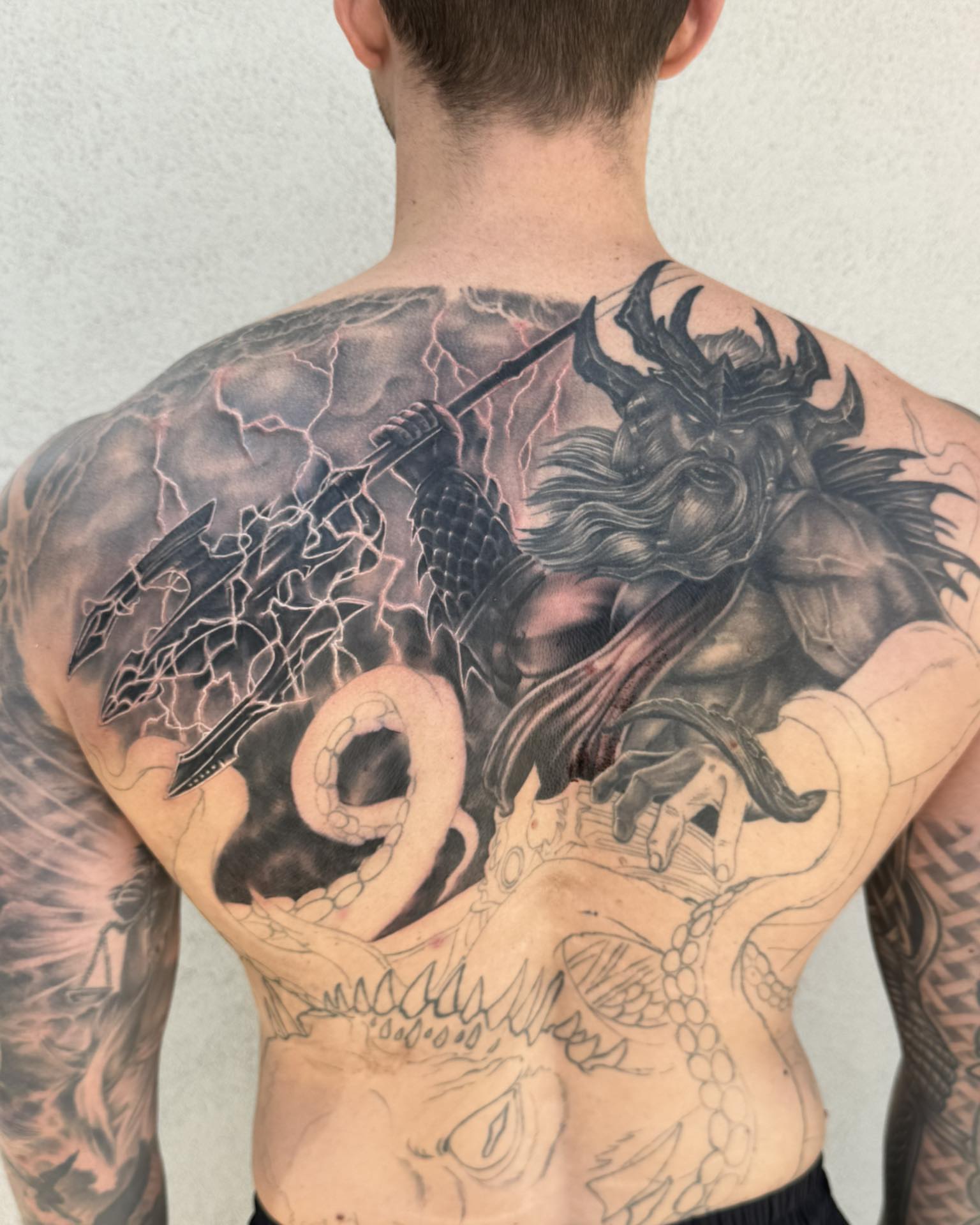 Demon slaying dragon realism tattoo on the back by Skott Kautman, Dubuque, Iowa