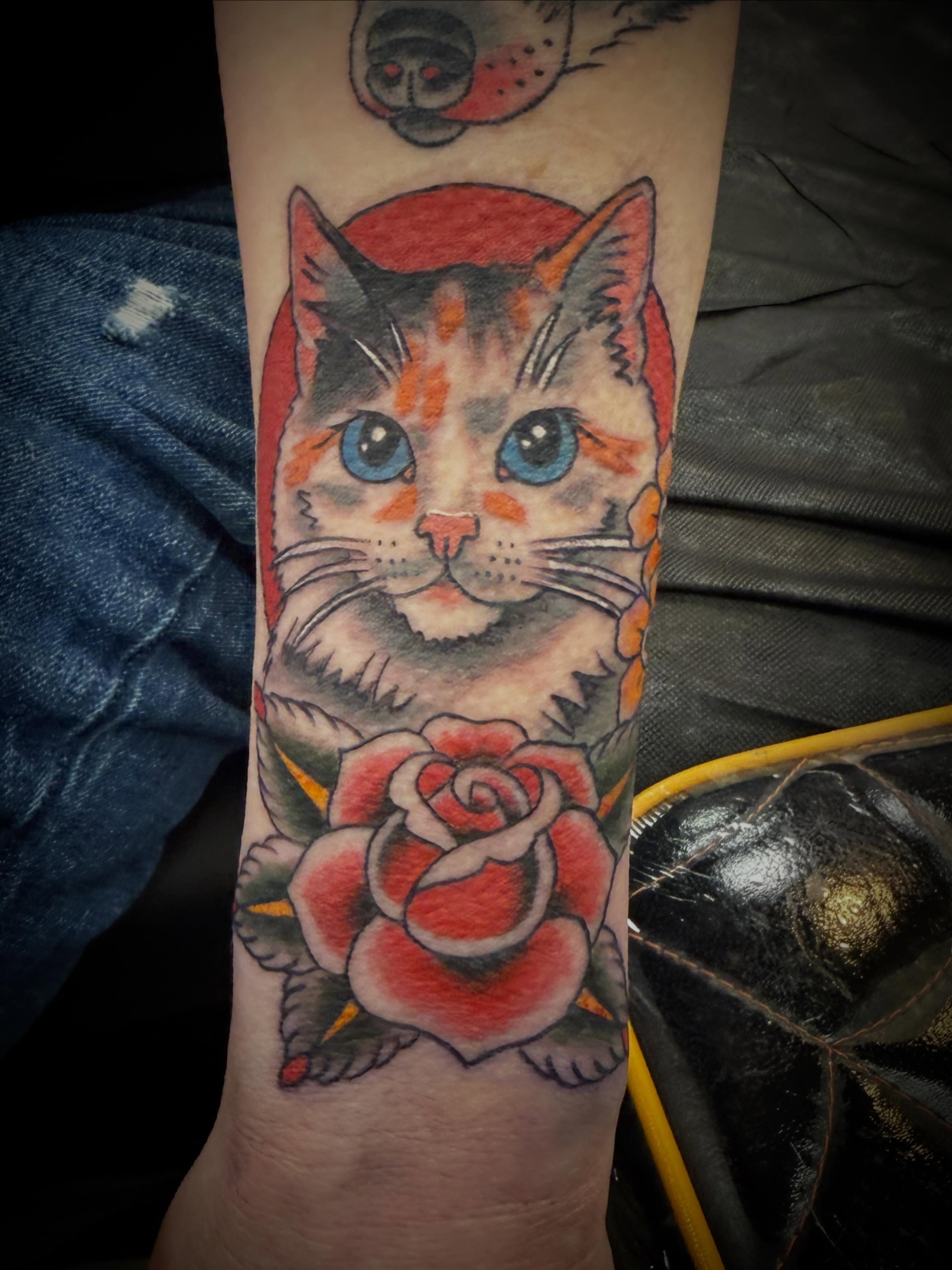 Cat and rose American traditional tattoo on the forearm by ArJay Smith