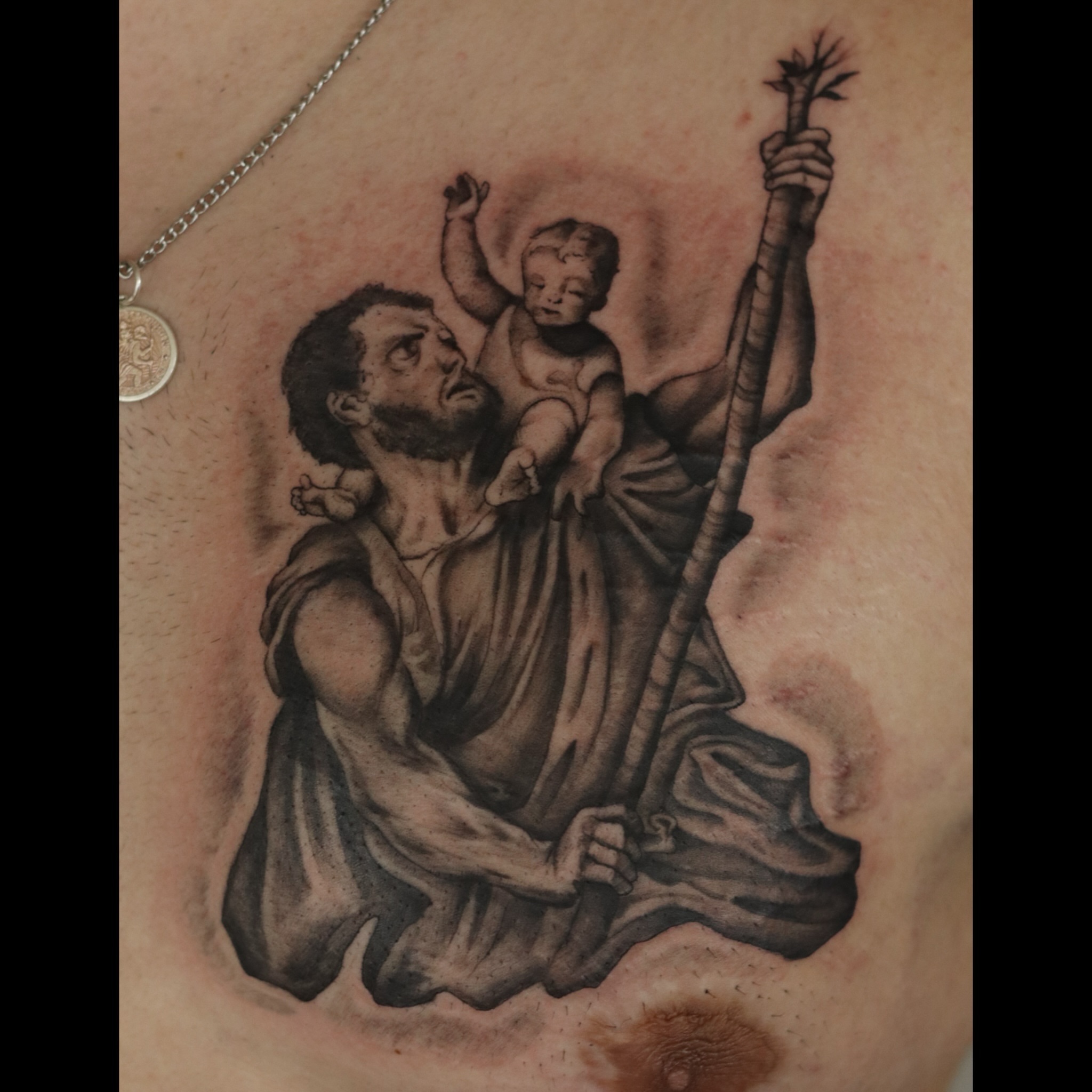 St. joseph with baby jesus realism tattoo on the thigh by Nik Checots