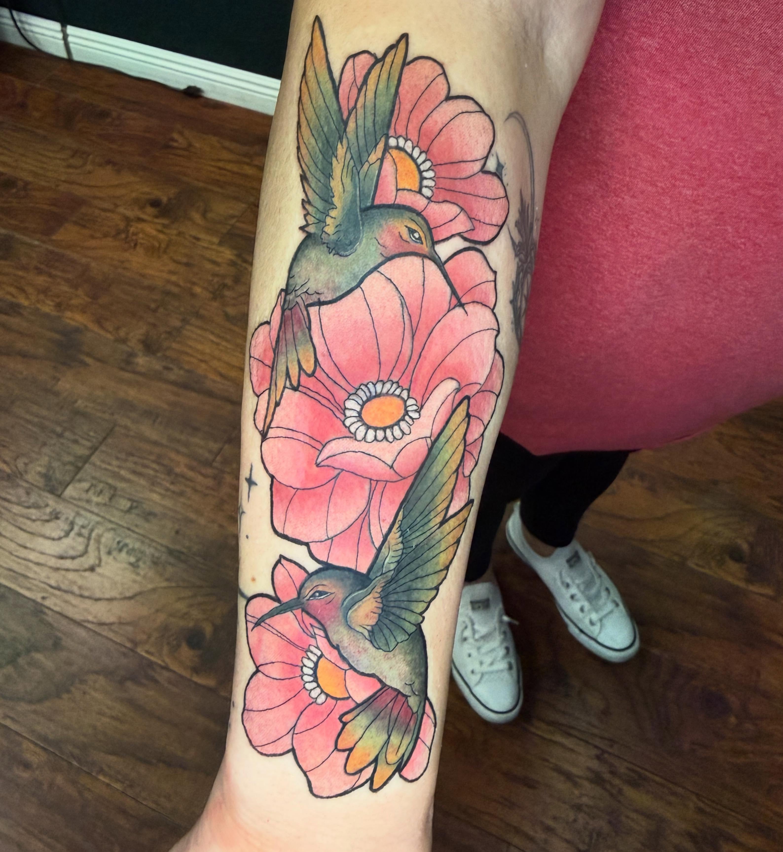 Hummingbird and flowers American traditional tattoo on the forearm by Emma ๐