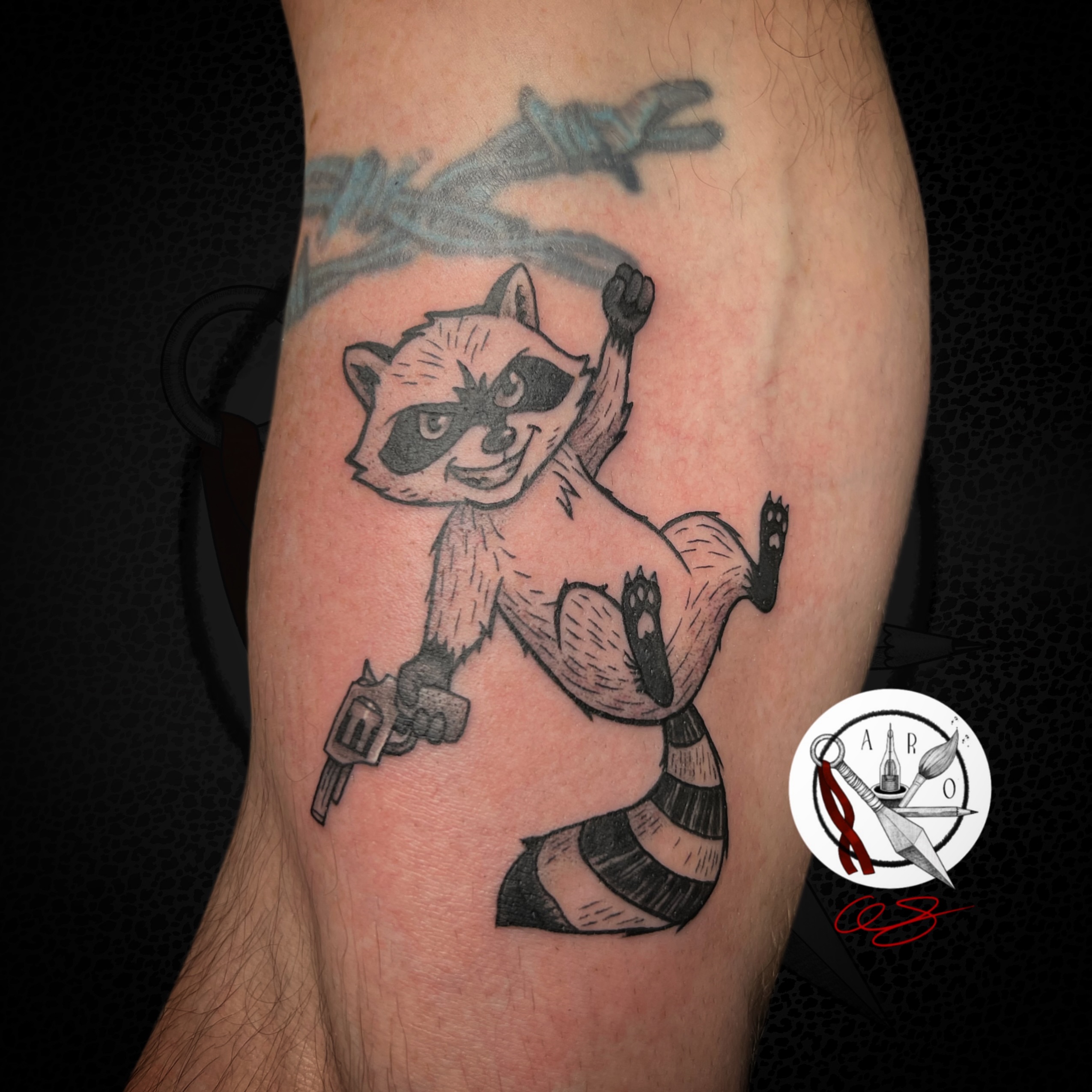 Raccoon black and grey tattoo on the forearm by Aaron Strobehn