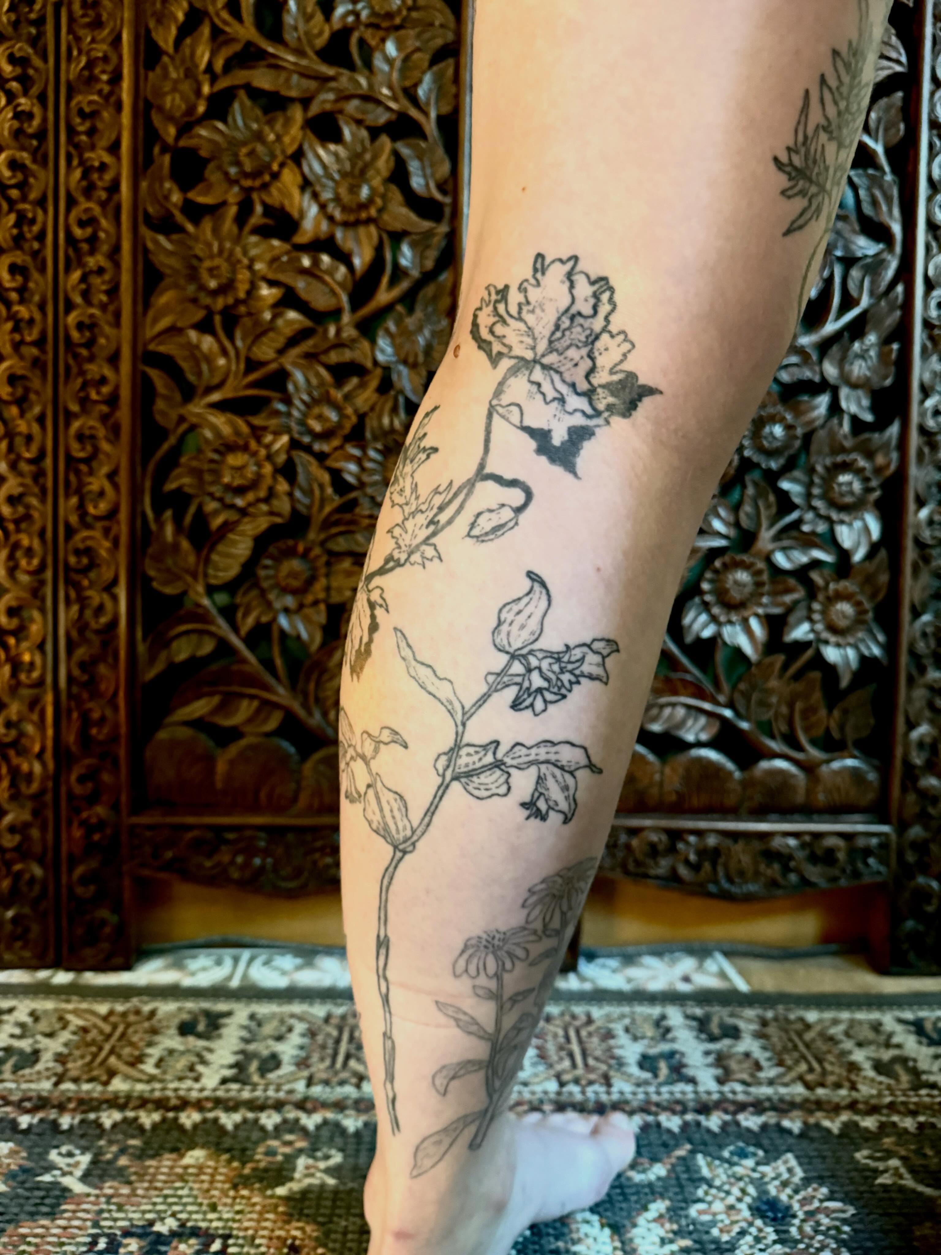 Botanical black and grey tattoo on the calf by Emily Rose Lumsdaine
