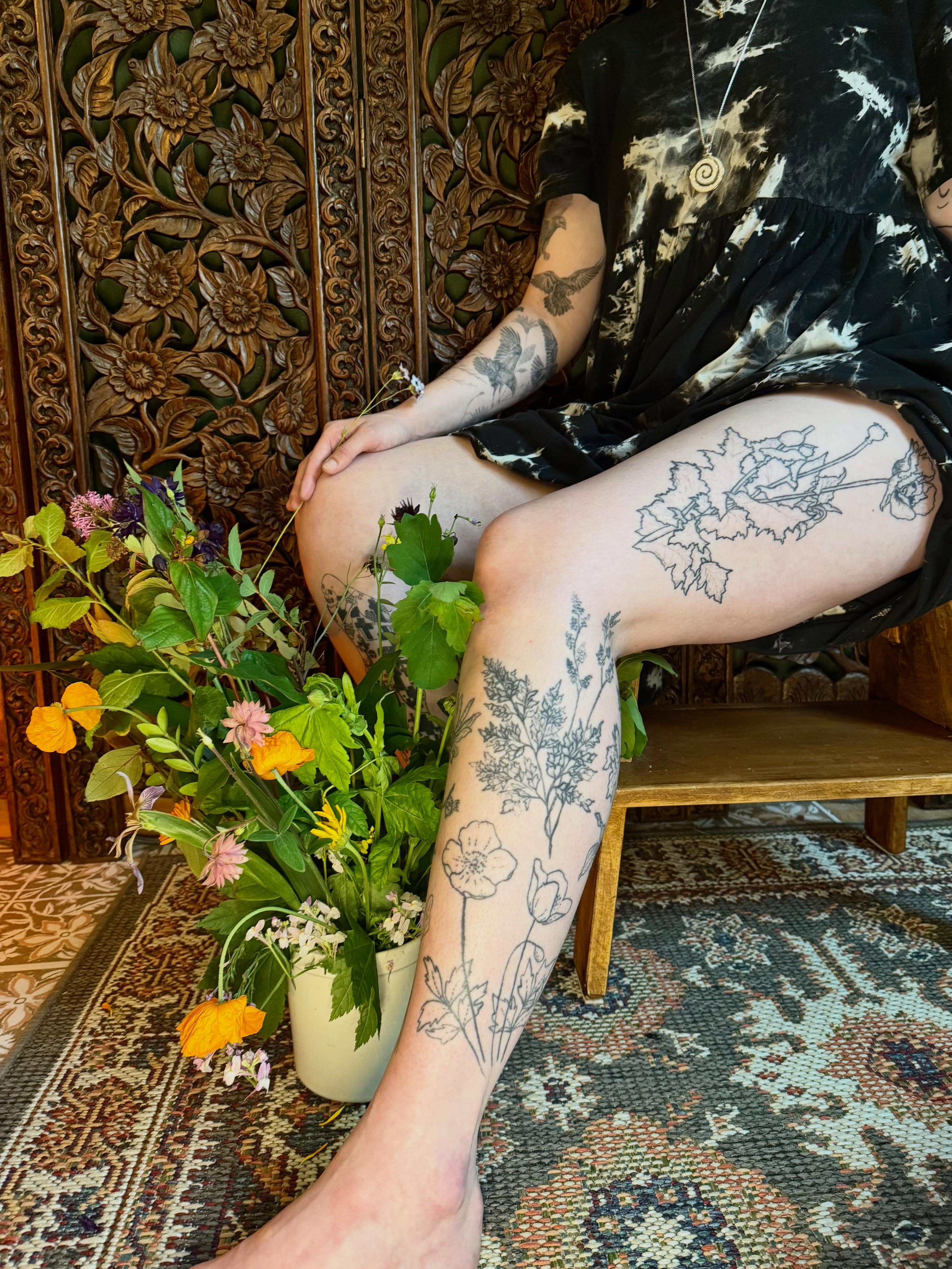 Botanical black and grey tattoo on the thigh by Emily Rose Lumsdaine